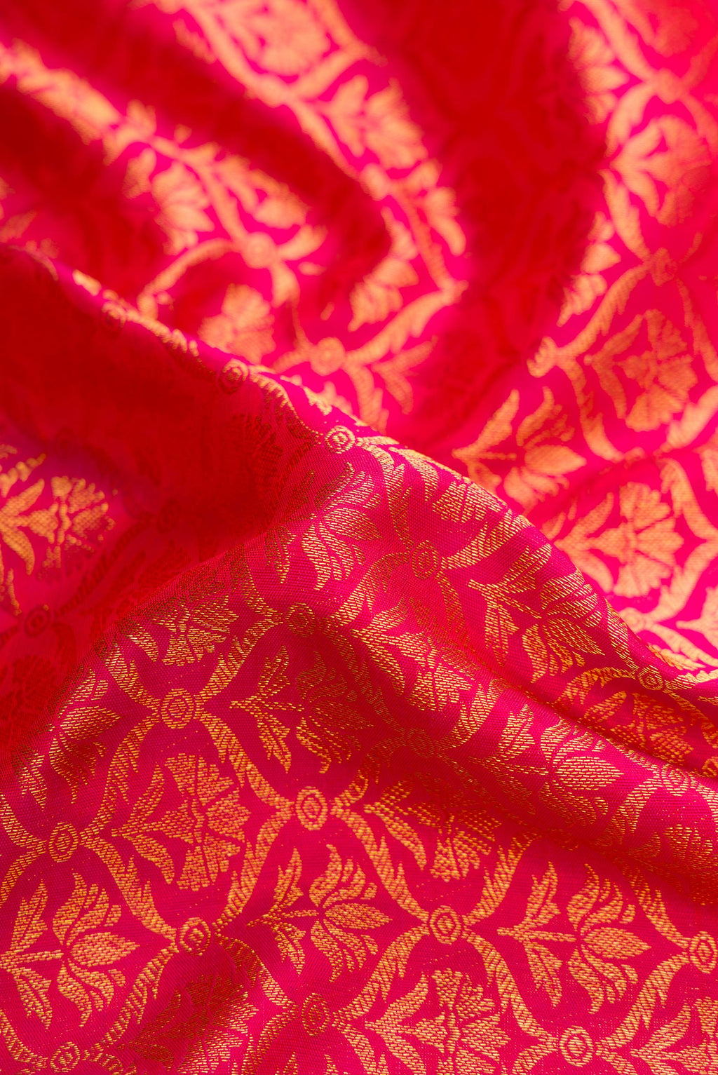 Close up of Pink Dual Tone Kanchipuram Silk Saree with Zari Brocade on the body and Zari Border.  displaying folds