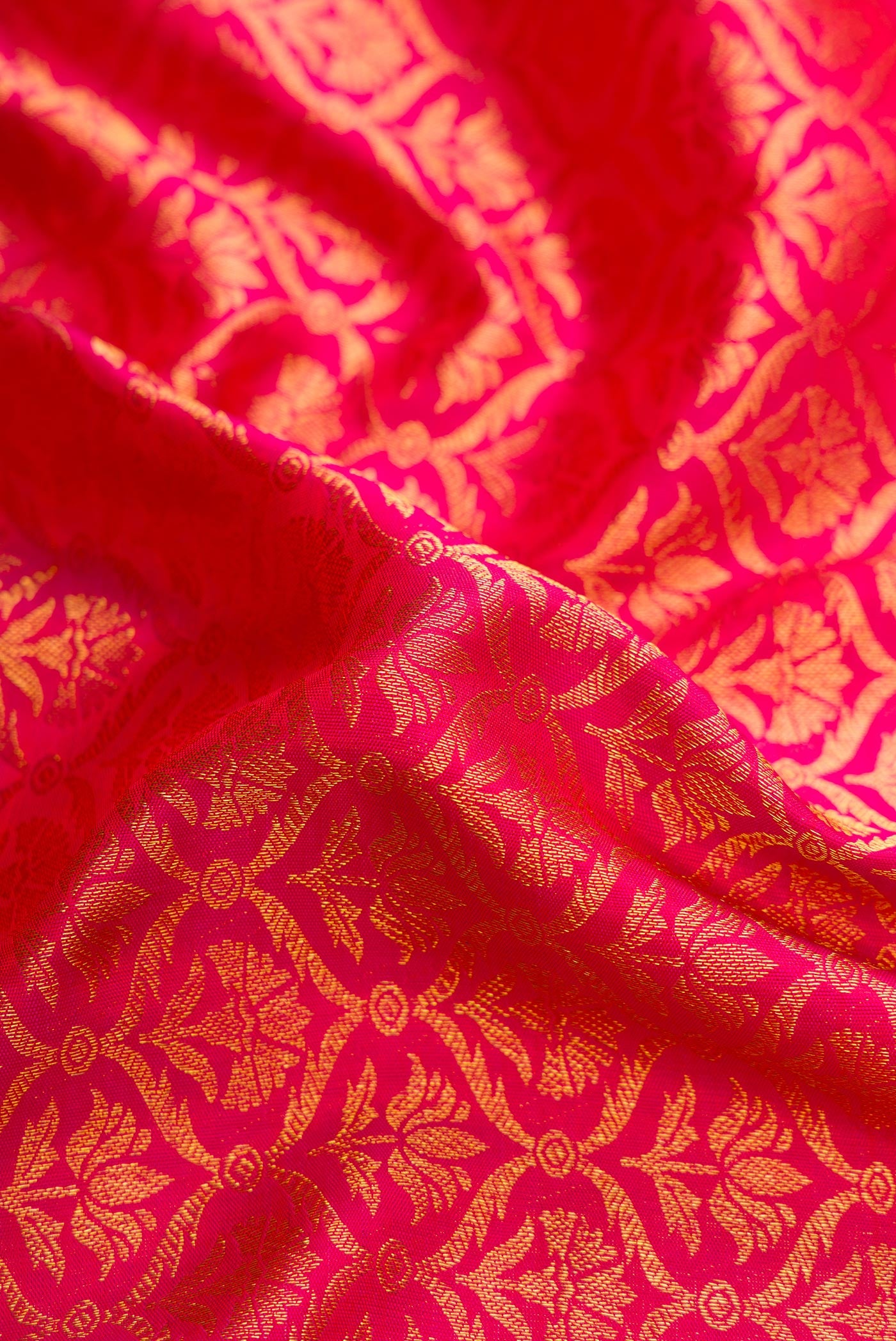 Close up of Pink Dual Tone Kanchipuram Silk Saree with Zari Brocade on the body and Zari Border.  displaying folds