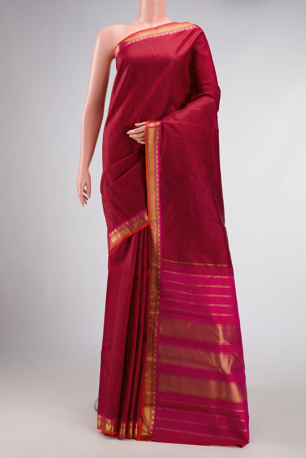 Maroon Dual Tone Kanjivaram Silk Saree with Plain Body and Zari Border.  displayed on a mannequin