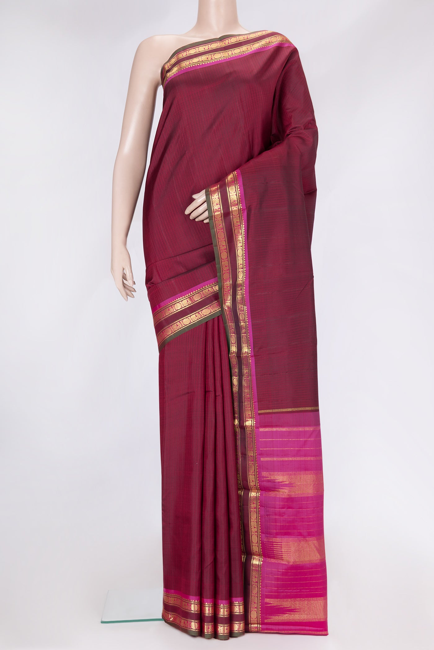 Maroon Dual Tone Kanjivaram Silk Saree with Stripes on the body and Zari Border.  displayed on a mannequin