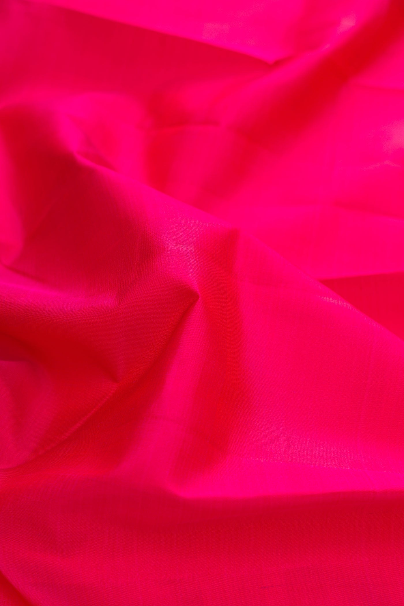 Close up of Pink Kanchipuram Silk Saree with Plain Body and Zari Border displaying folds