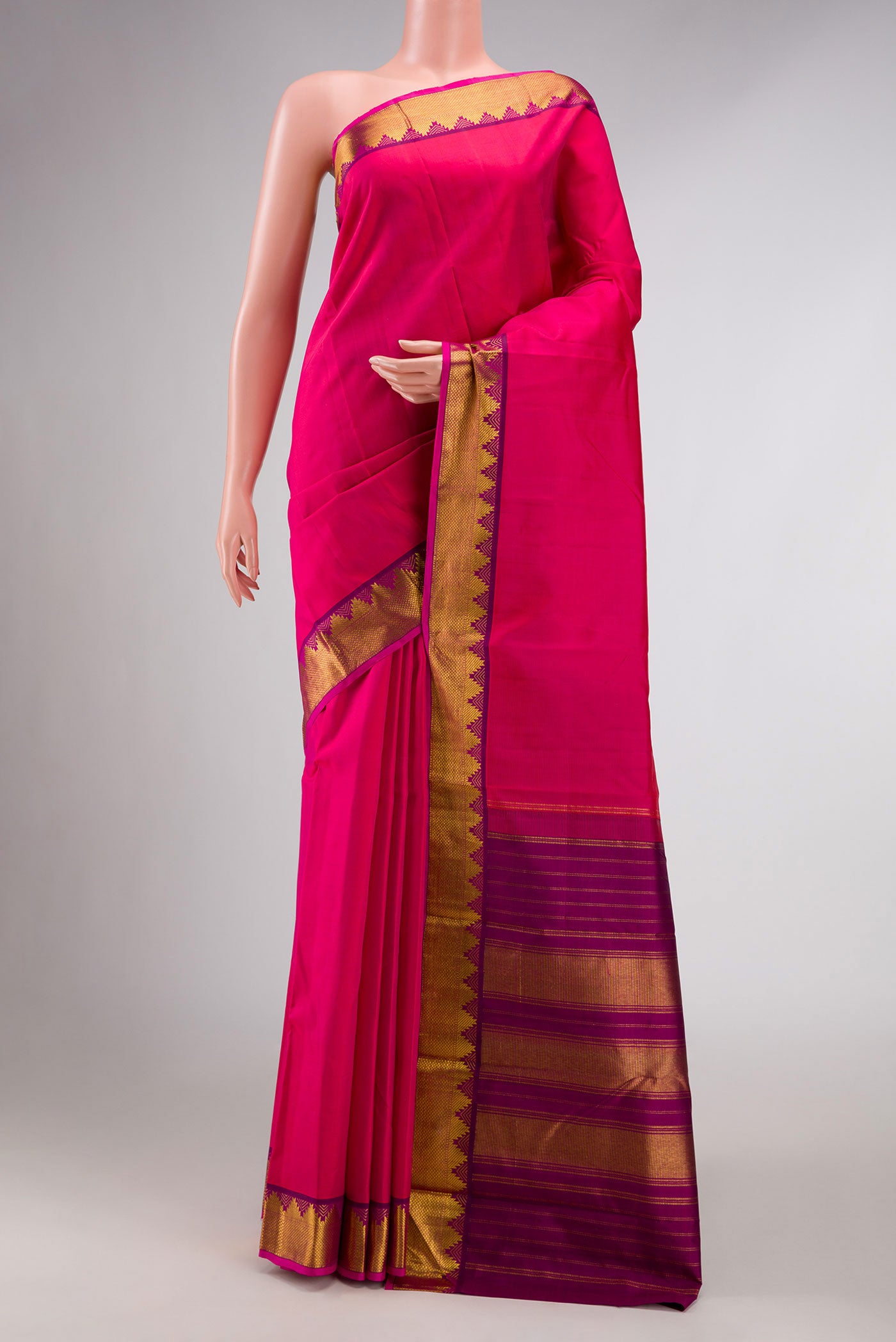 Pink Kanchipuram Silk Saree with Plain Body and Zari Border displayed on a mannequin