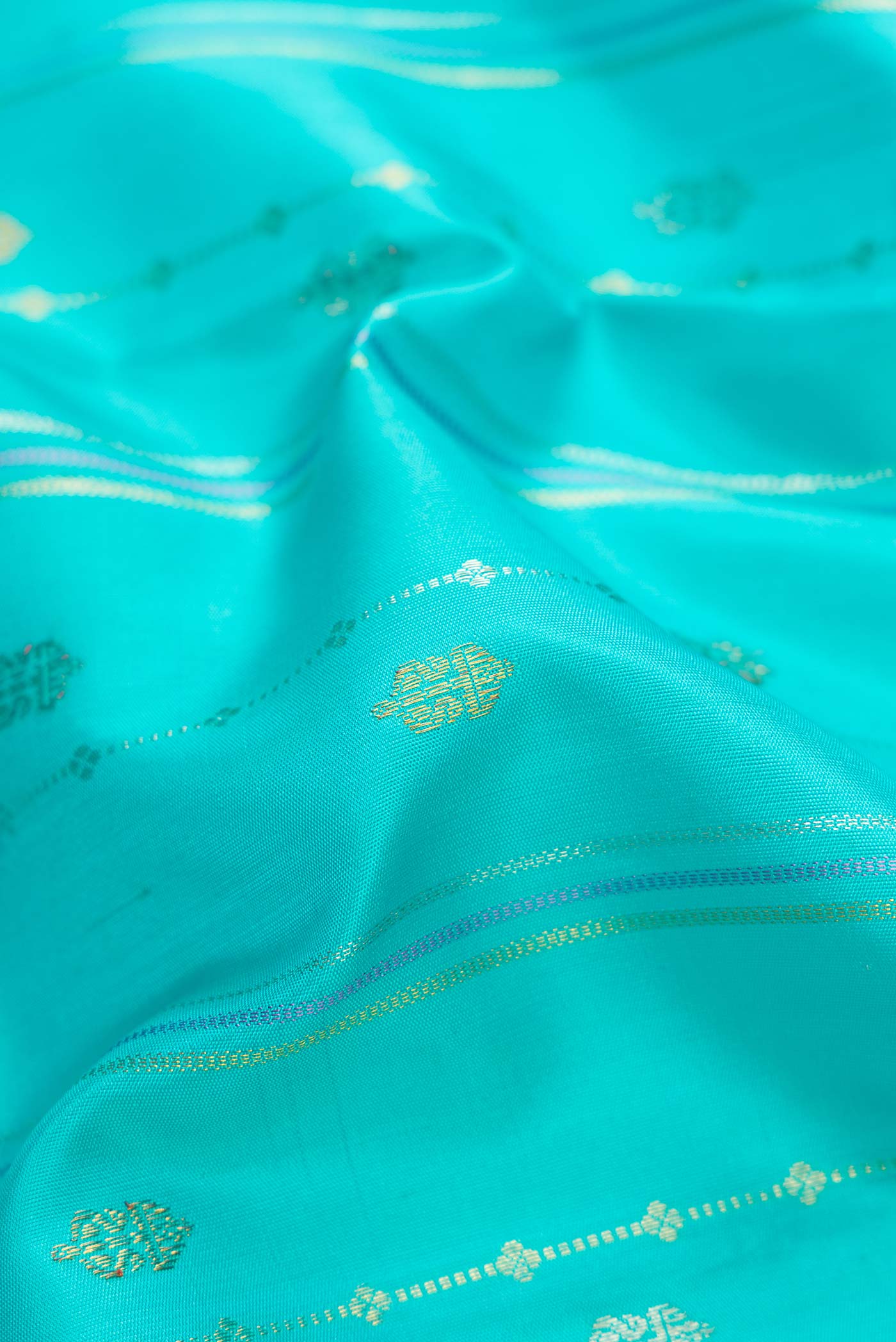 Close up of Sky Blue Dual Tone Kanchipuram Silk Saree with Stripes on the body and Fancy Border.  displaying folds