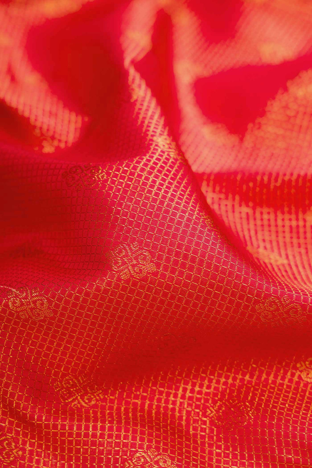Close up of Red Dual Tone Kanjivaram Silk Saree with Zari Brocade on the body and Zari Border.  displaying folds