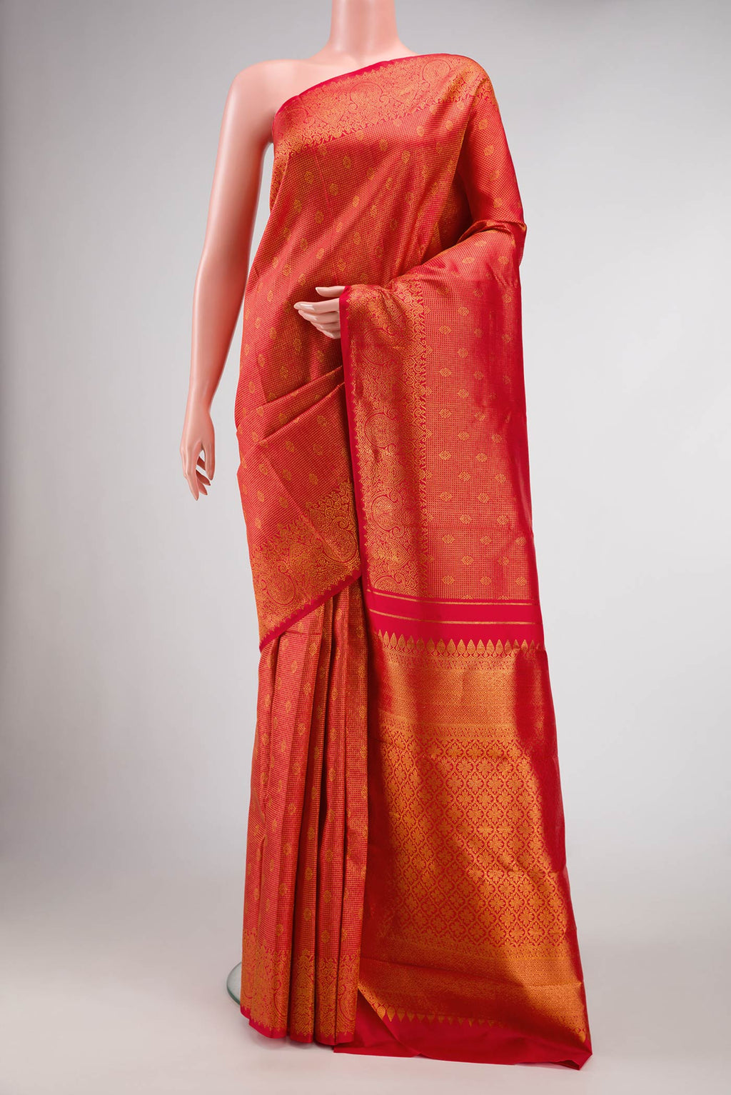 Red Dual Tone Kanjivaram Silk Saree with Zari Brocade on the body and Zari Border.  displayed on a mannequin