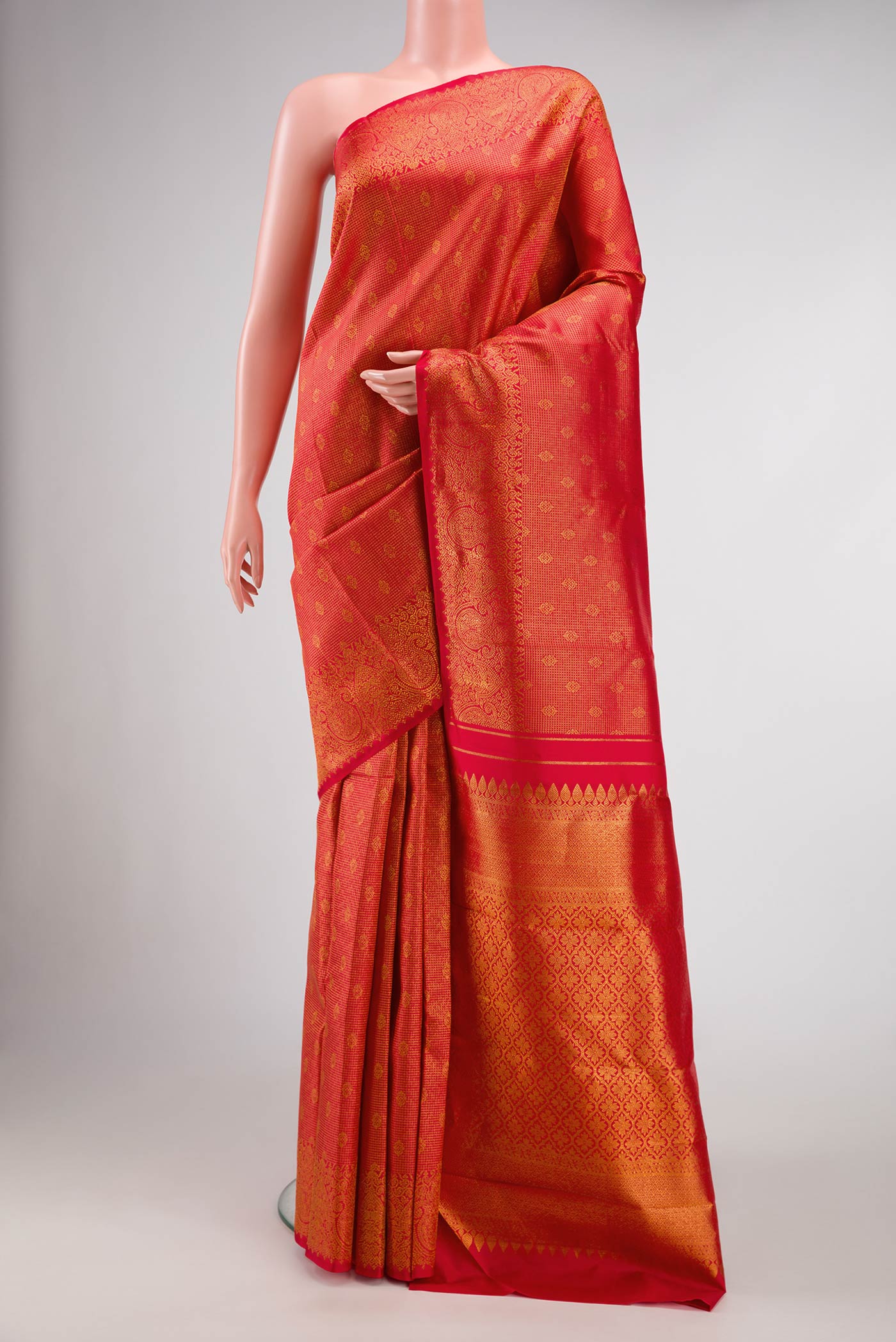 Red Dual Tone Kanjivaram Silk Saree with Zari Brocade on the body and Zari Border.  displayed on a mannequin