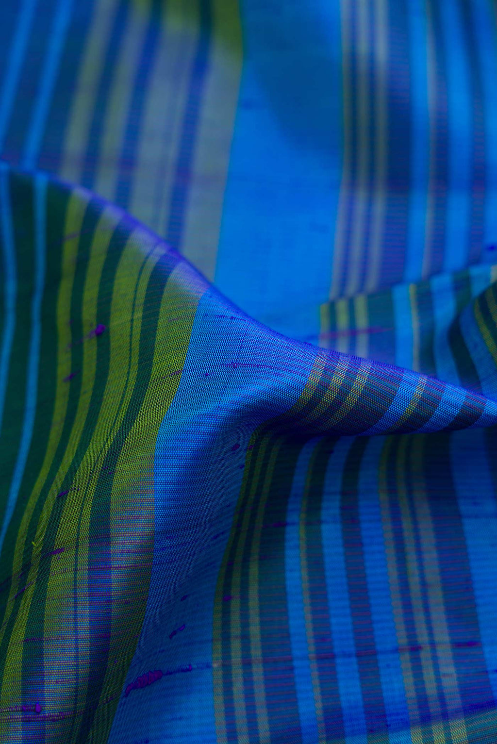 Close up of Blue Dual Tone Kanchipuram Silk Saree with Stripes on the body and Zari Border displaying folds