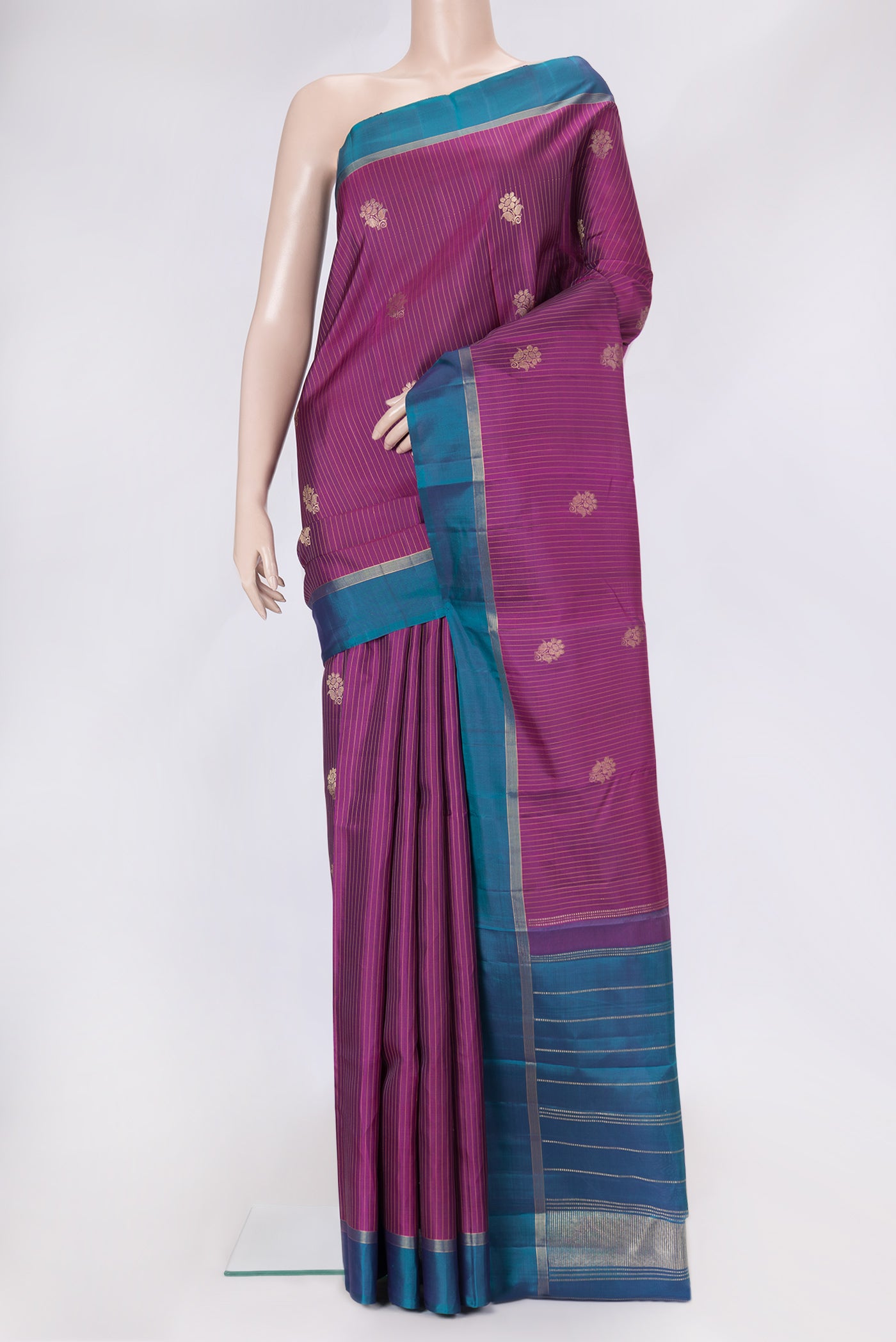 Magenta Dual Tone Kanjivaram Silk Saree with Stripes on the body and Zari Border.  displayed on a mannequin