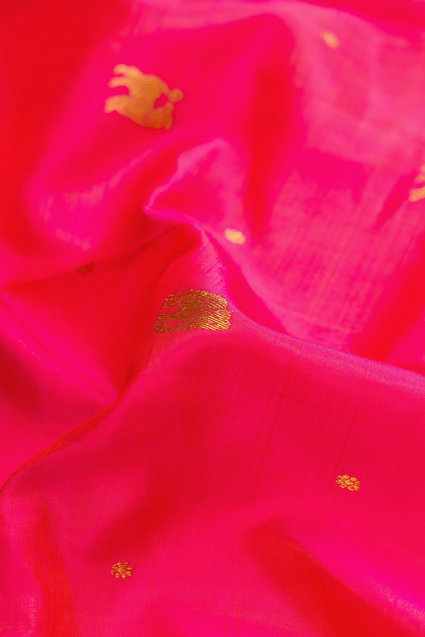 Close up of Pure Silk Pure Zari Pink Dual Tone Kanchipuram Saree with Zari Butta on the body and Zari Border displaying folds