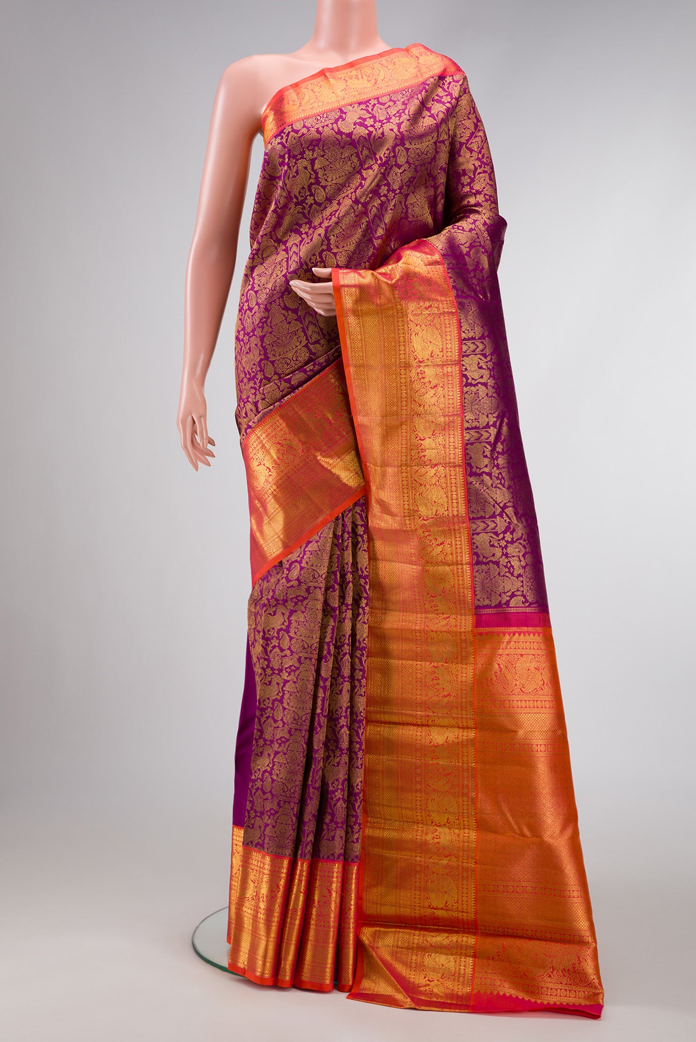 Magenta Dual Tone Kanchipuram Silk Saree with Zari Brocade on the body and Zari Border.  displayed on a mannequin
