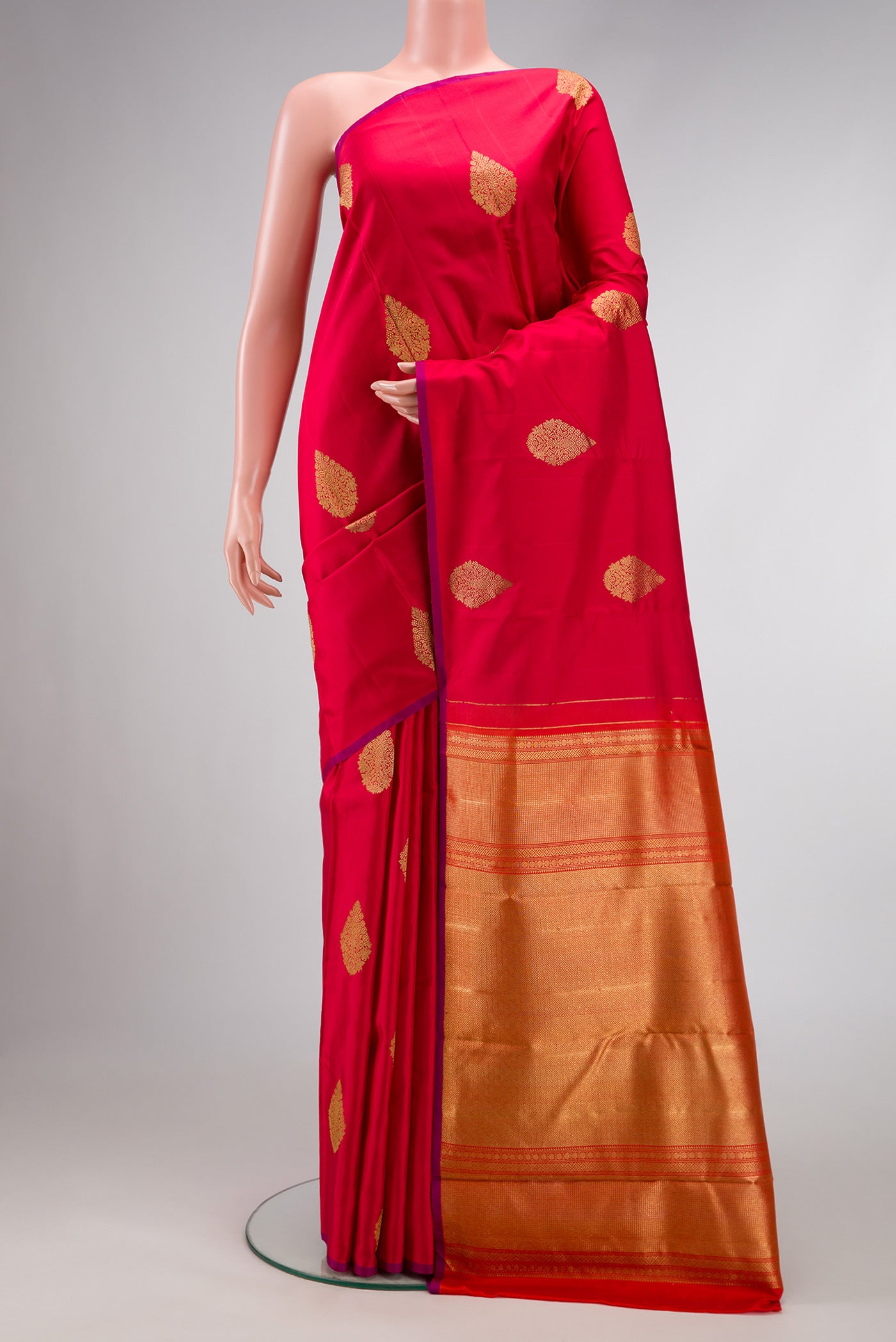 Pure Silk Pure Zari Red Dual Tone Kanchipuram Saree with Zari Butta on the body and Without Border.  displayed on a mannequin