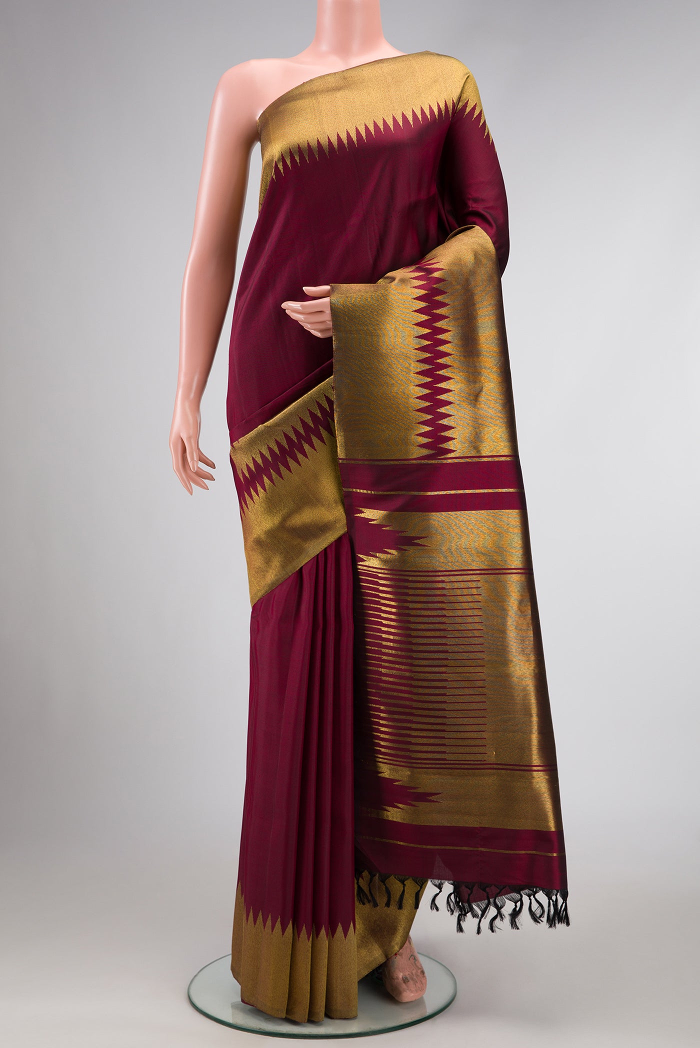 Pure Silk Pure Zari Maroon Dual Tone Kanchipuram Saree with Plain Body and Rising Temple Border.  displayed on a mannequin