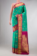 Pure Silk Pure Zari Sea Green Dual Tone Kanchipuram Saree with Zari Butta on the body and Zari Border displayed on a mannequin