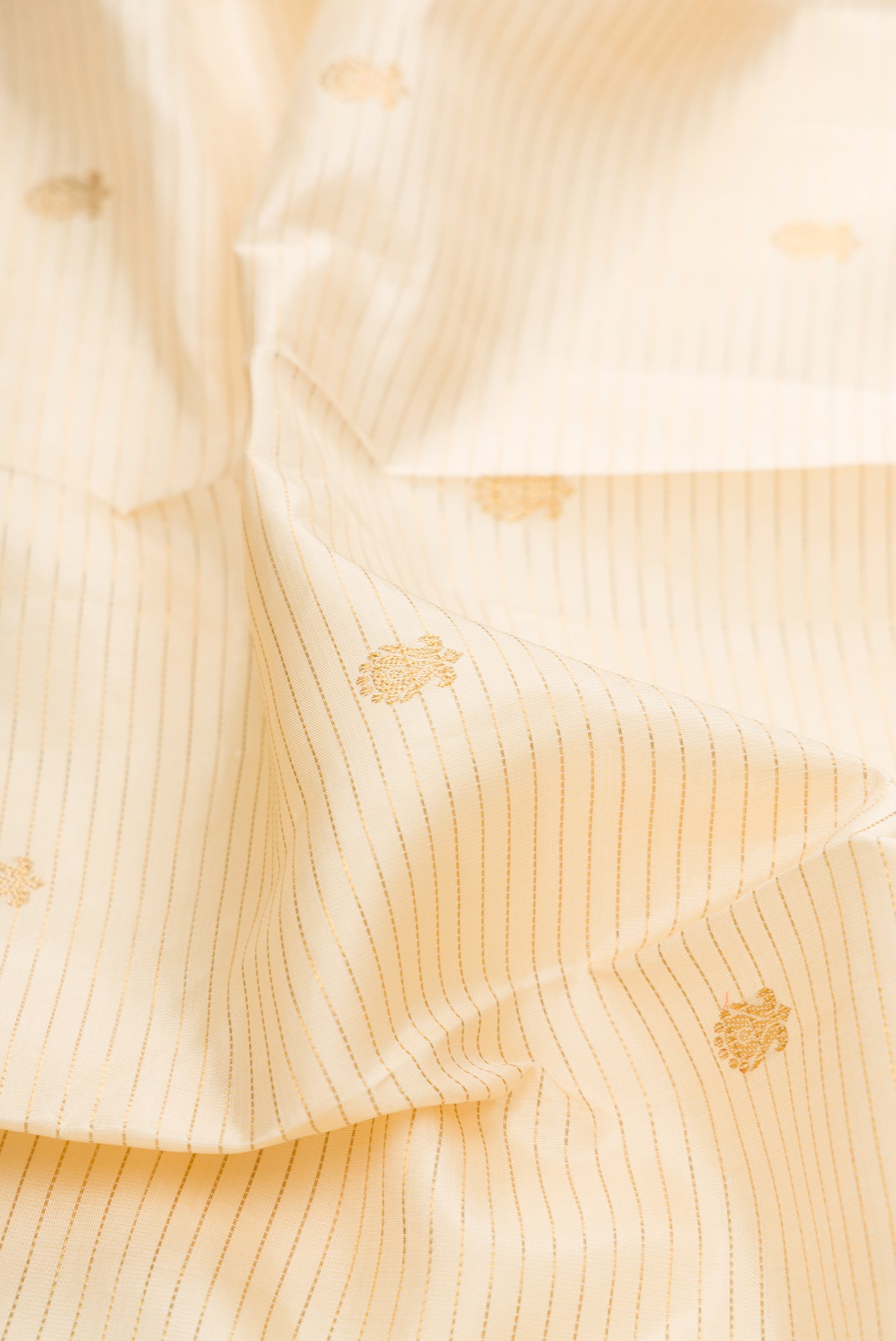 Close up of Sandal Dual Tone Kanchipuram Silk Saree with Zari Butta on the body and Zari Border.  displaying folds