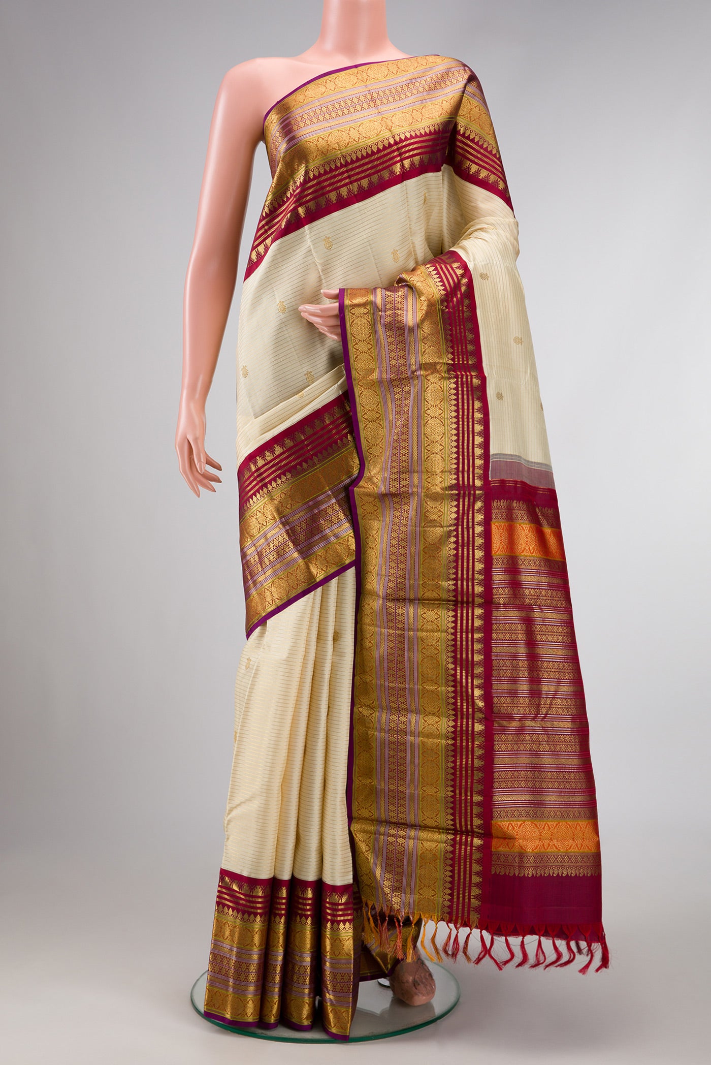 Sandal Dual Tone Kanchipuram Silk Saree with Zari Butta on the body and Zari Border.  displayed on a mannequin