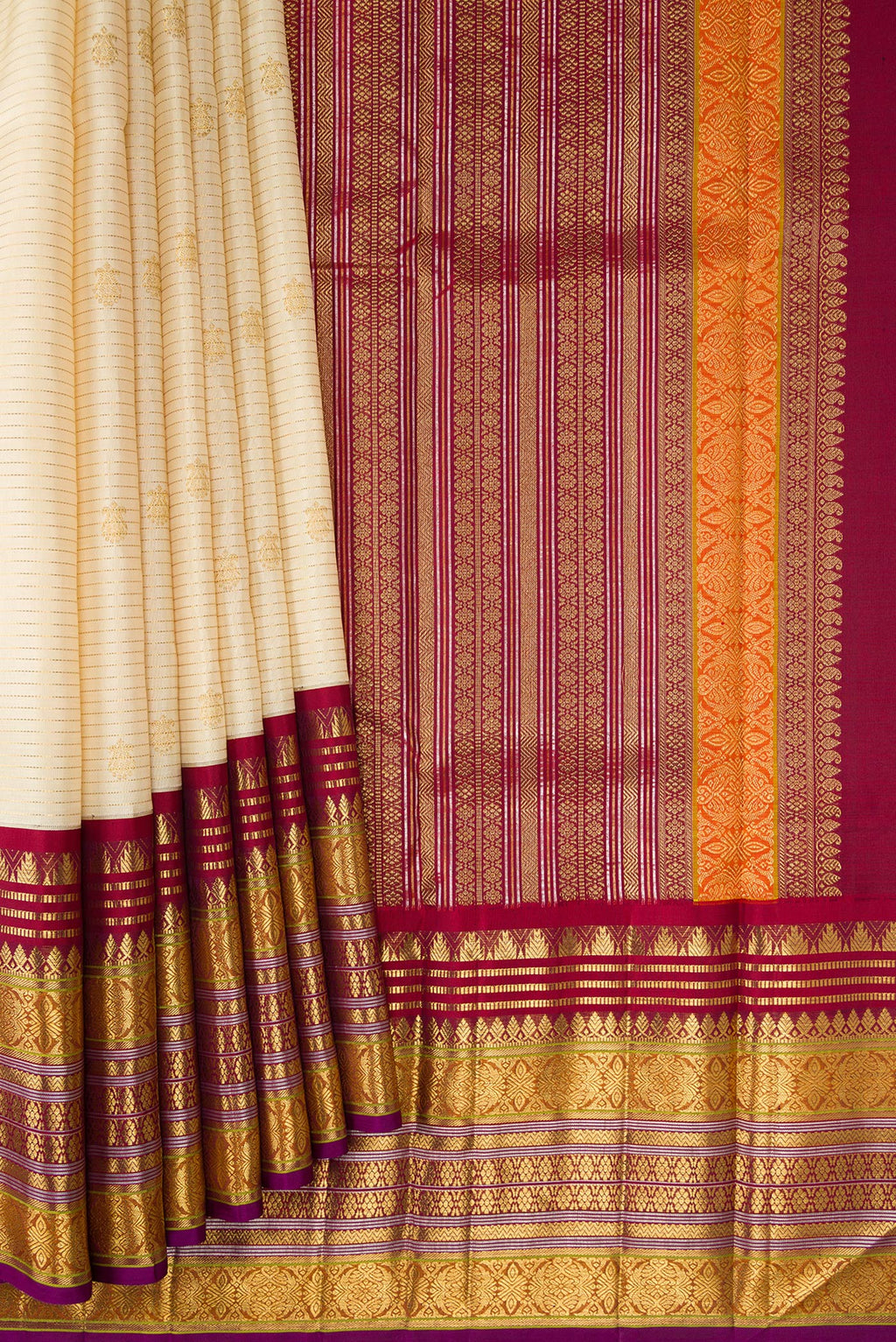 Pleats and pallu of Sandal Dual Tone Kanchipuram Silk Saree with Zari Butta on the body and Zari Border. 