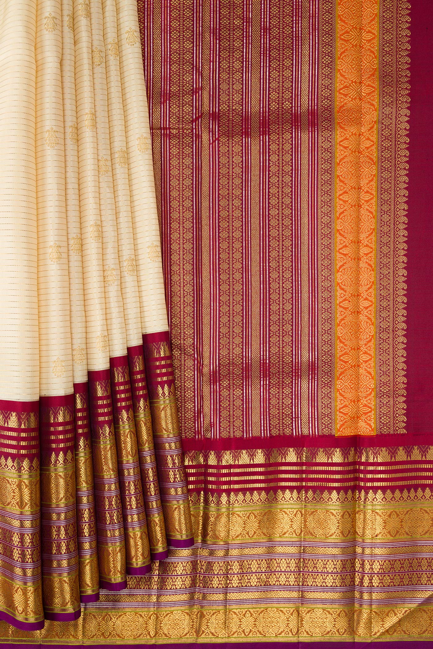 Pleats and pallu of Sandal Dual Tone Kanchipuram Silk Saree with Zari Butta on the body and Zari Border. 