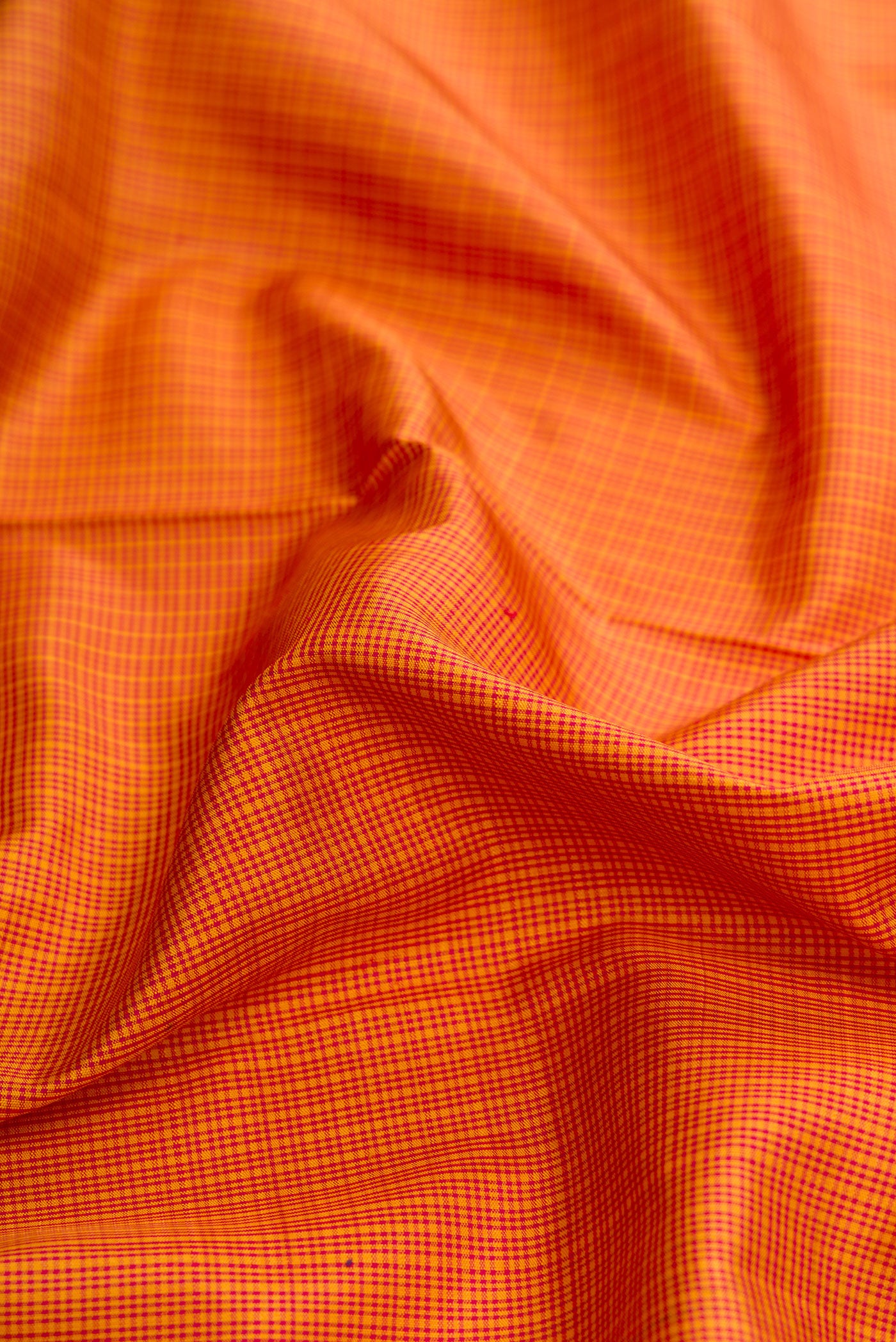Close up of Mustard Dual Tone Kanjivaram Silk Saree with Checked design on the body and Zari Border.  displaying folds
