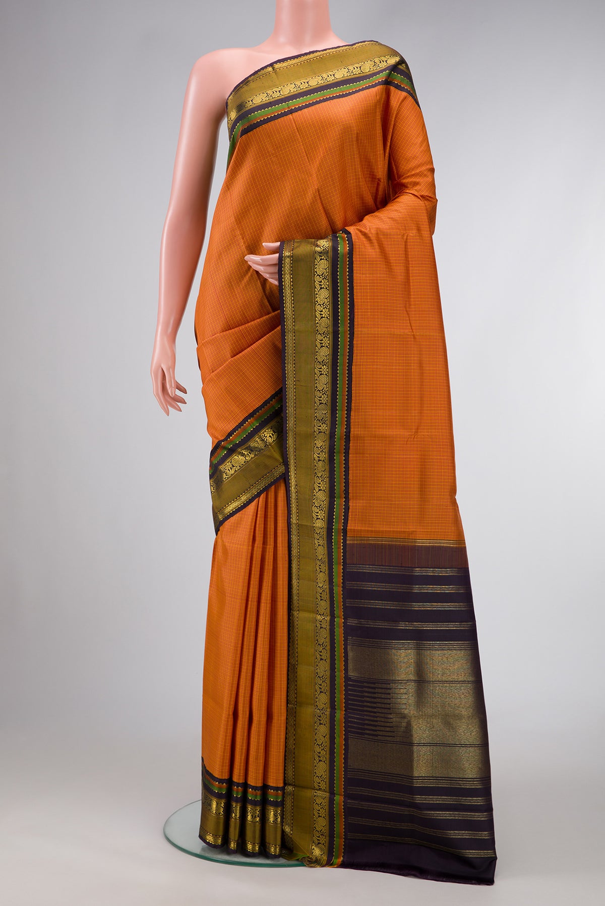 Mustard Dual Tone Kanjivaram Silk Saree with Checked design on the body and Zari Border.  displayed on a mannequin