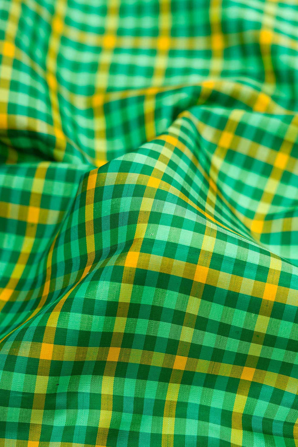 Close up of Pure Silk Pure Zari Green and Yellow Color Kanjivaram Saree with Checked design on the body and Zari Border.  displaying folds