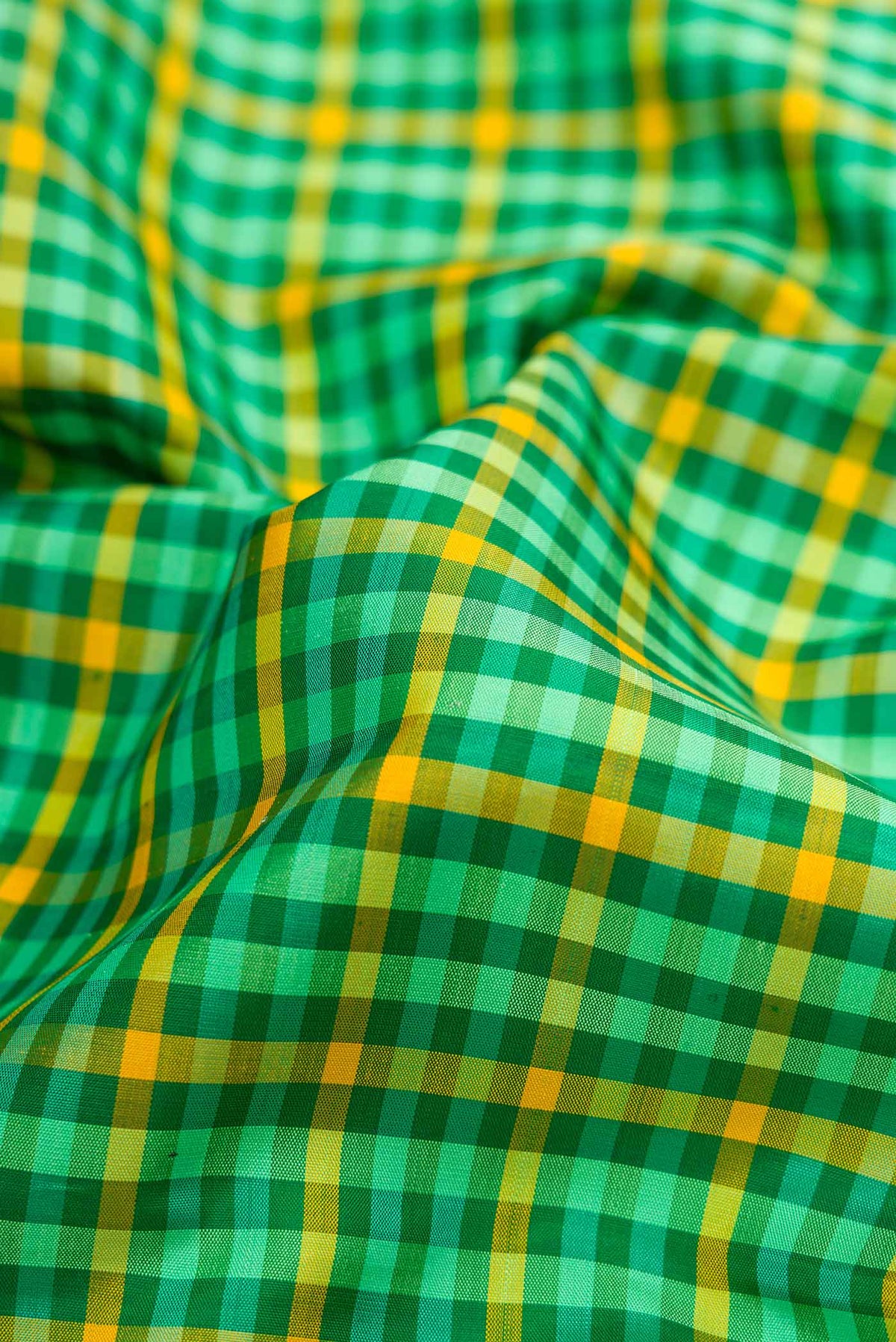 Close up of Pure Silk Pure Zari Green and Yellow Color Kanjivaram Saree with Checked design on the body and Zari Border.  displaying folds