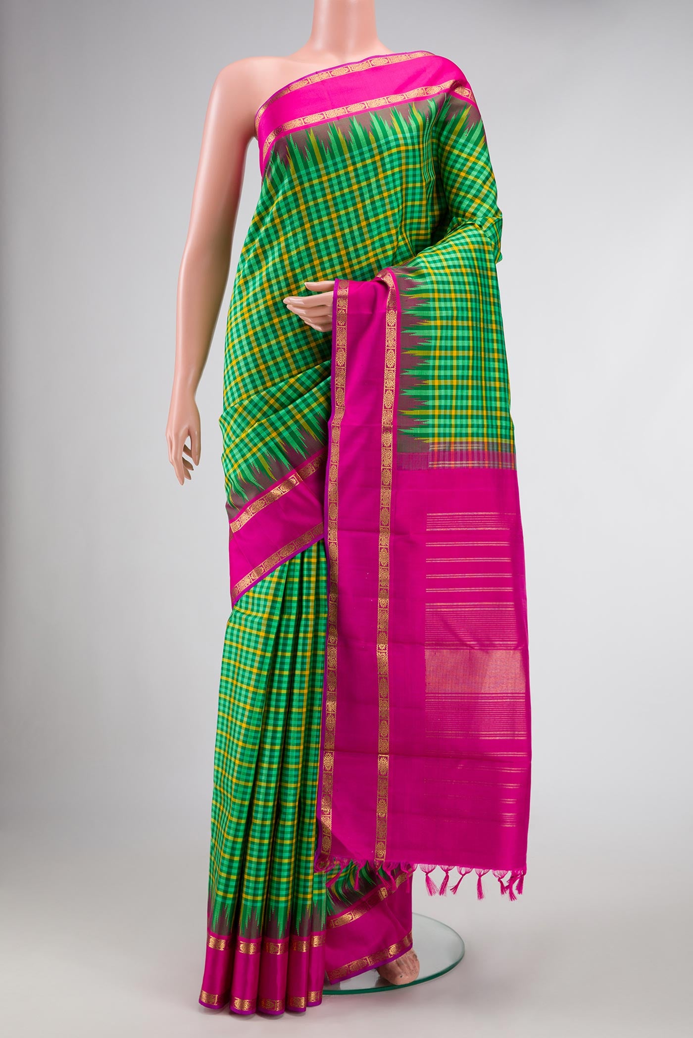 Pure Silk Pure Zari Green and Yellow Color Kanjivaram Saree with Checked design on the body and Zari Border.  displayed on a mannequin