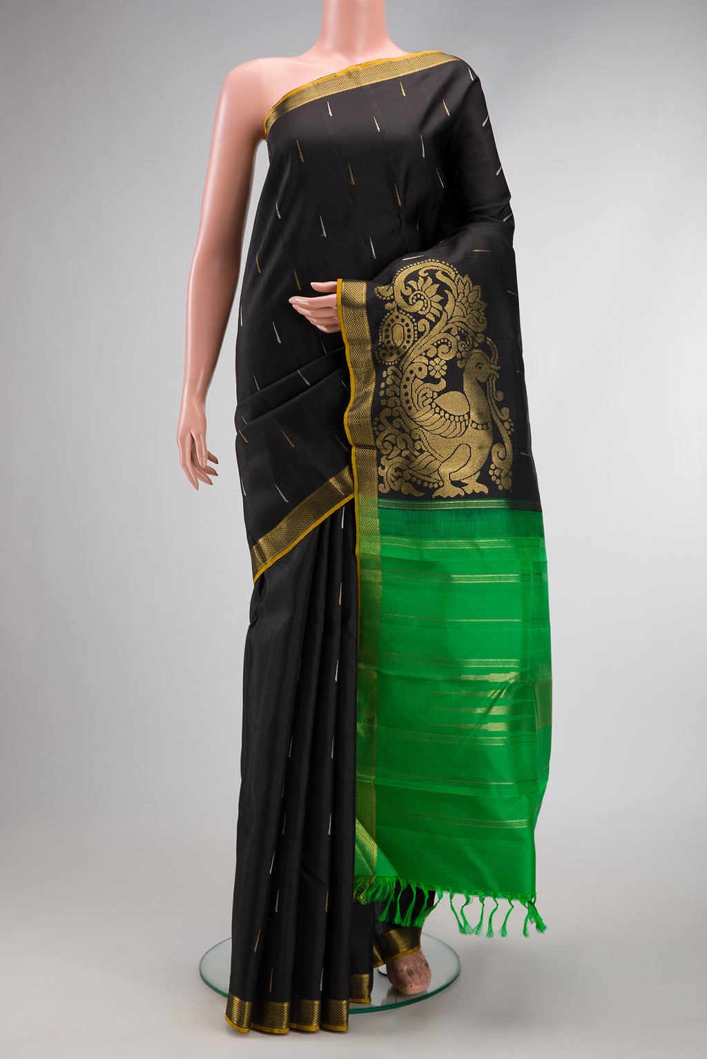 Black Kanjivaram Silk Saree with Zari Butta on the body and Zari Border.  displayed on a mannequin