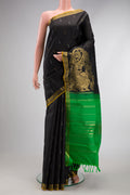 Black Kanjivaram Silk Saree with Zari Butta on the body and Zari Border.  displayed on a mannequin