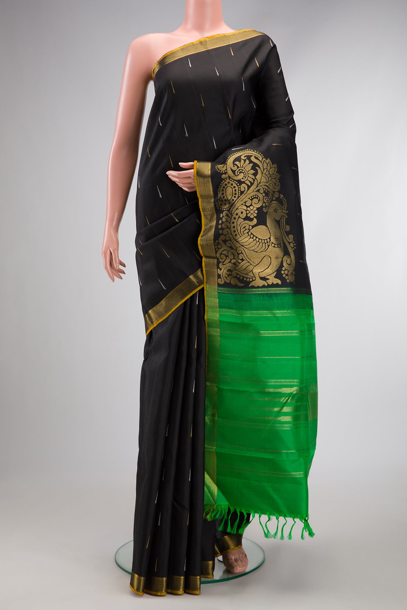 Black Kanjivaram Silk Saree with Zari Butta on the body and Zari Border.  displayed on a mannequin