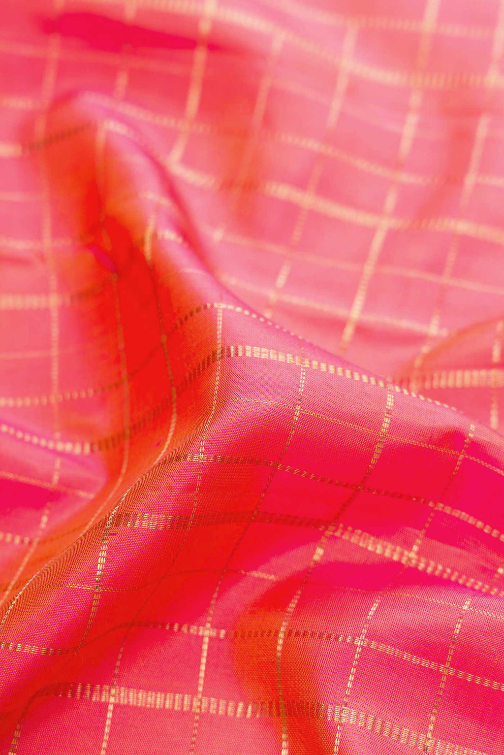 Close up of Pink with Orange Color Kanchipuram Silk Saree with Checked design on the body and Zari Border displaying folds