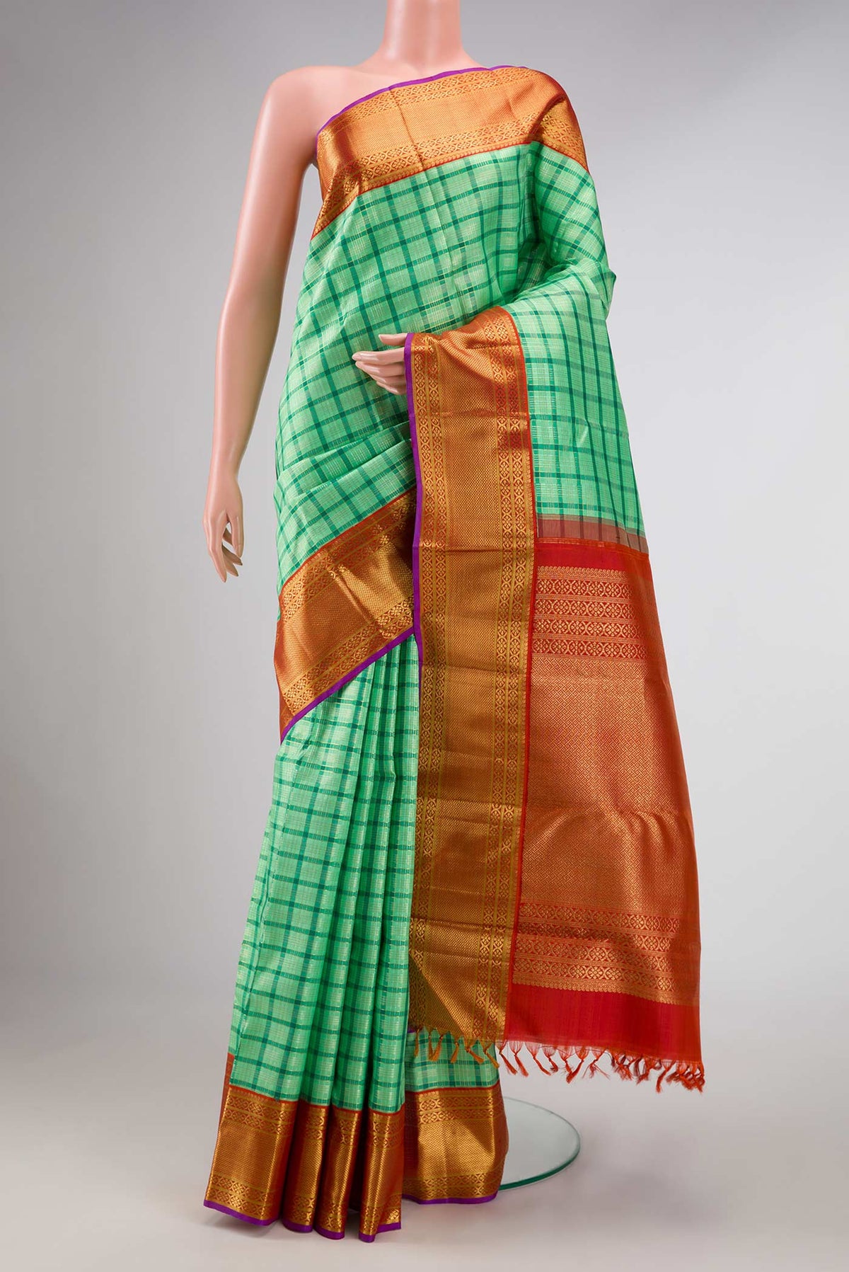 Pure Silk Pure Zari Sea Green Dual Tone Kanchipuram Saree with Checked design on the body and Zari Border displayed on a mannequin