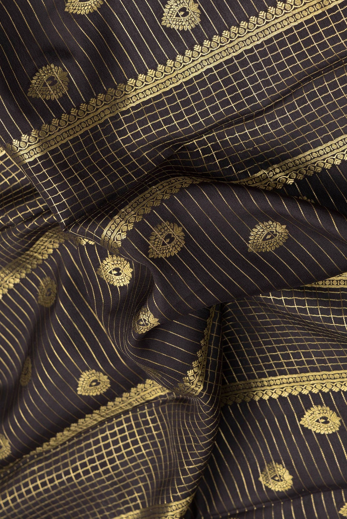 Close up of Coffee Brown Mysore Crepe Saree with Checked design on the body and Zari Border.  displaying folds