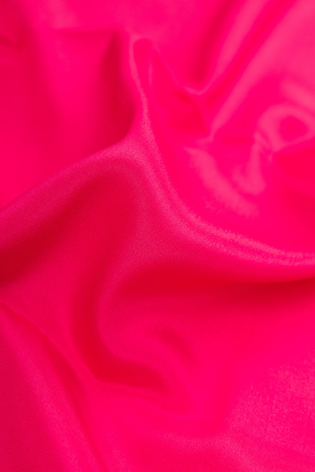 Close up of Pink Mysore Crepe Saree with Plain Body and Zari Border.  displaying folds