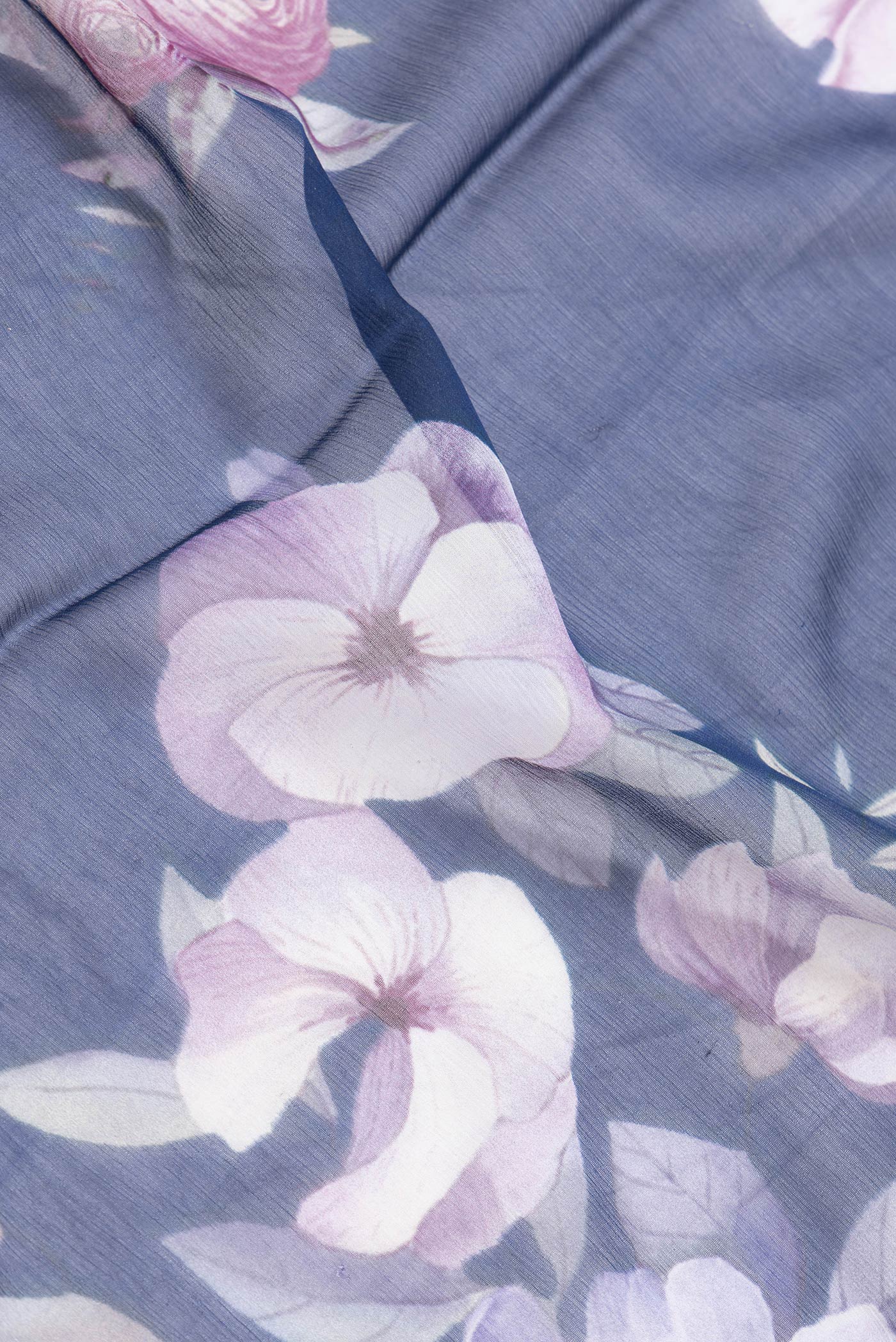 Close up of Navy Blue Dual Tone Chiffon Saree with Printed design on the body and Without Border.  displaying folds