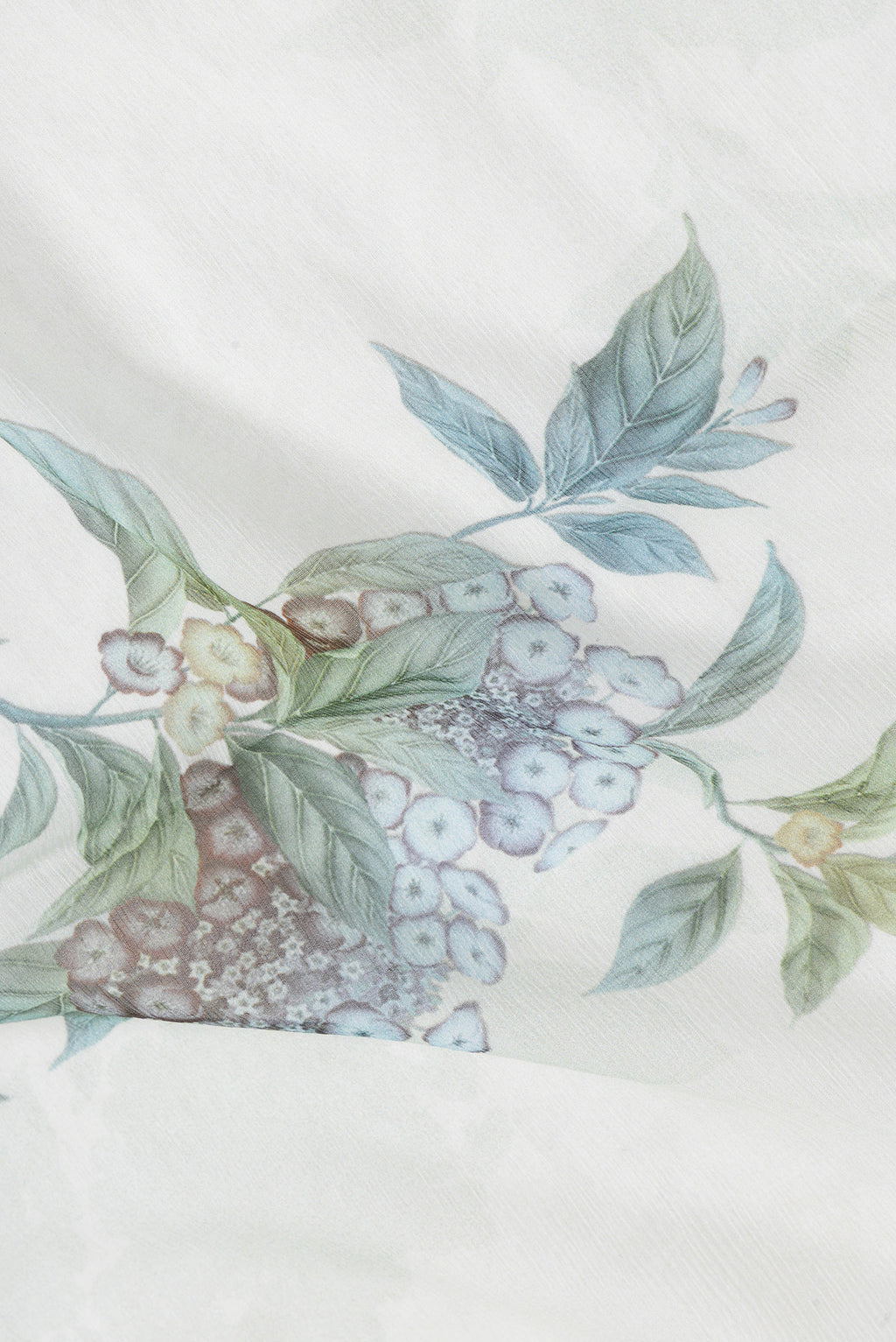 Close up of Pista Green Dual Tone Mysore Chiffon Saree with Printed design on the body and Without Border.  displaying folds