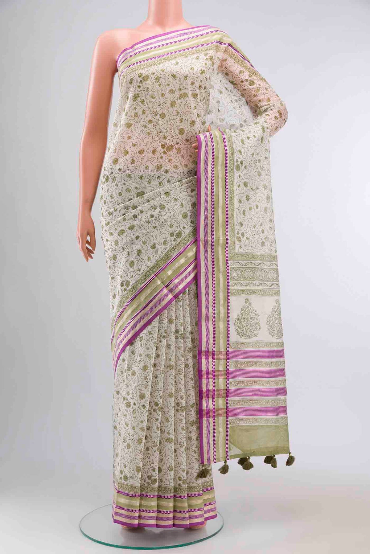 White Silk Cotton Saree with Printed design on the body and Zari Border displayed on a mannequin