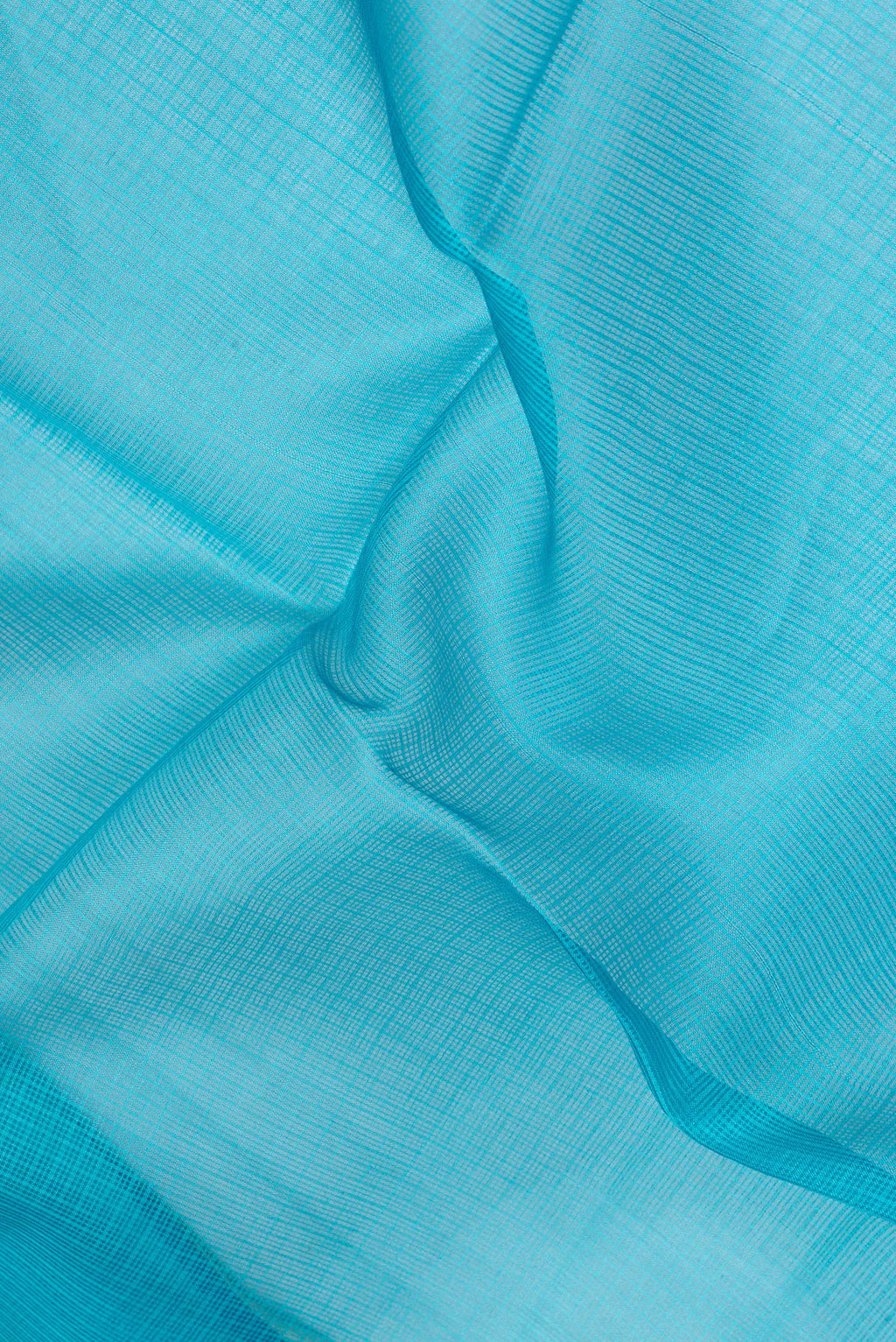 Close up of Sky Blue Kota Silk Saree with Printed design on the body and Fancy Border.  displaying folds