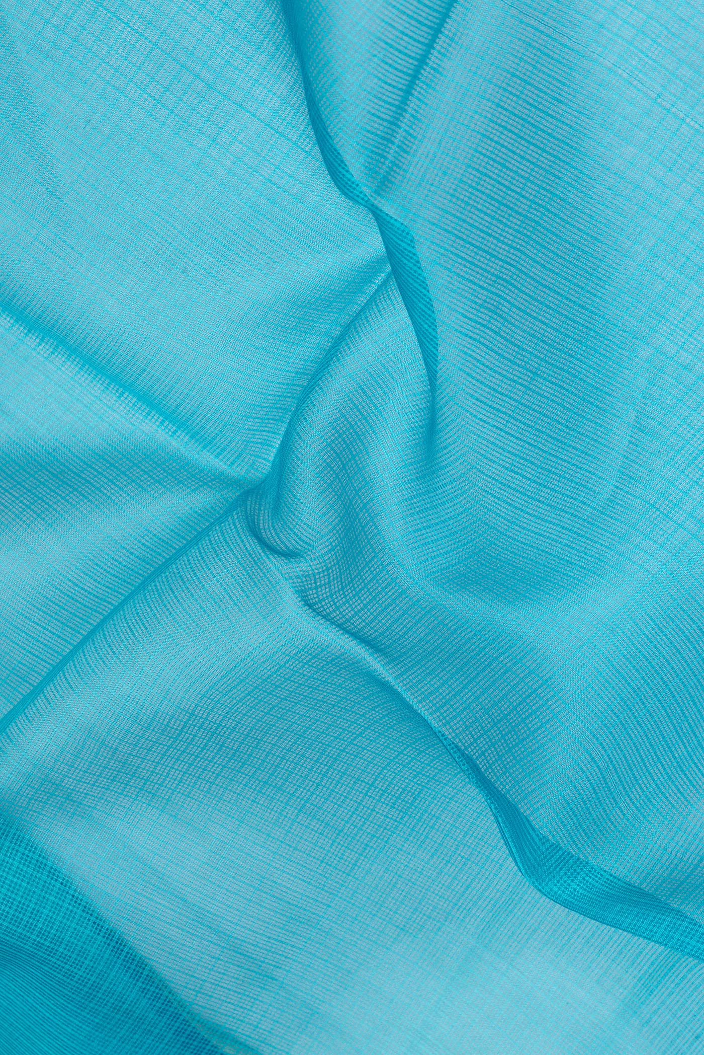 Close up of Sky Blue Kota Silk Saree with Printed design on the body and Fancy Border.  displaying folds