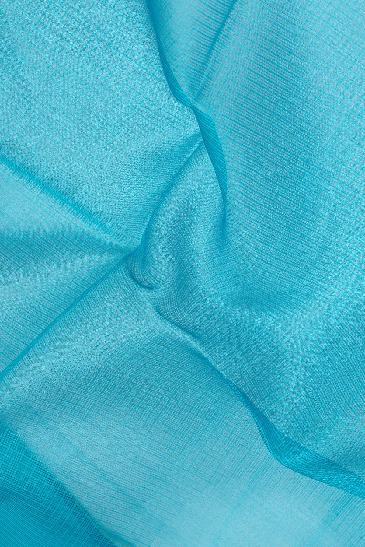 Close up of Sky Blue Kota Silk Saree with Printed design on the body and Fancy Border.  displaying folds