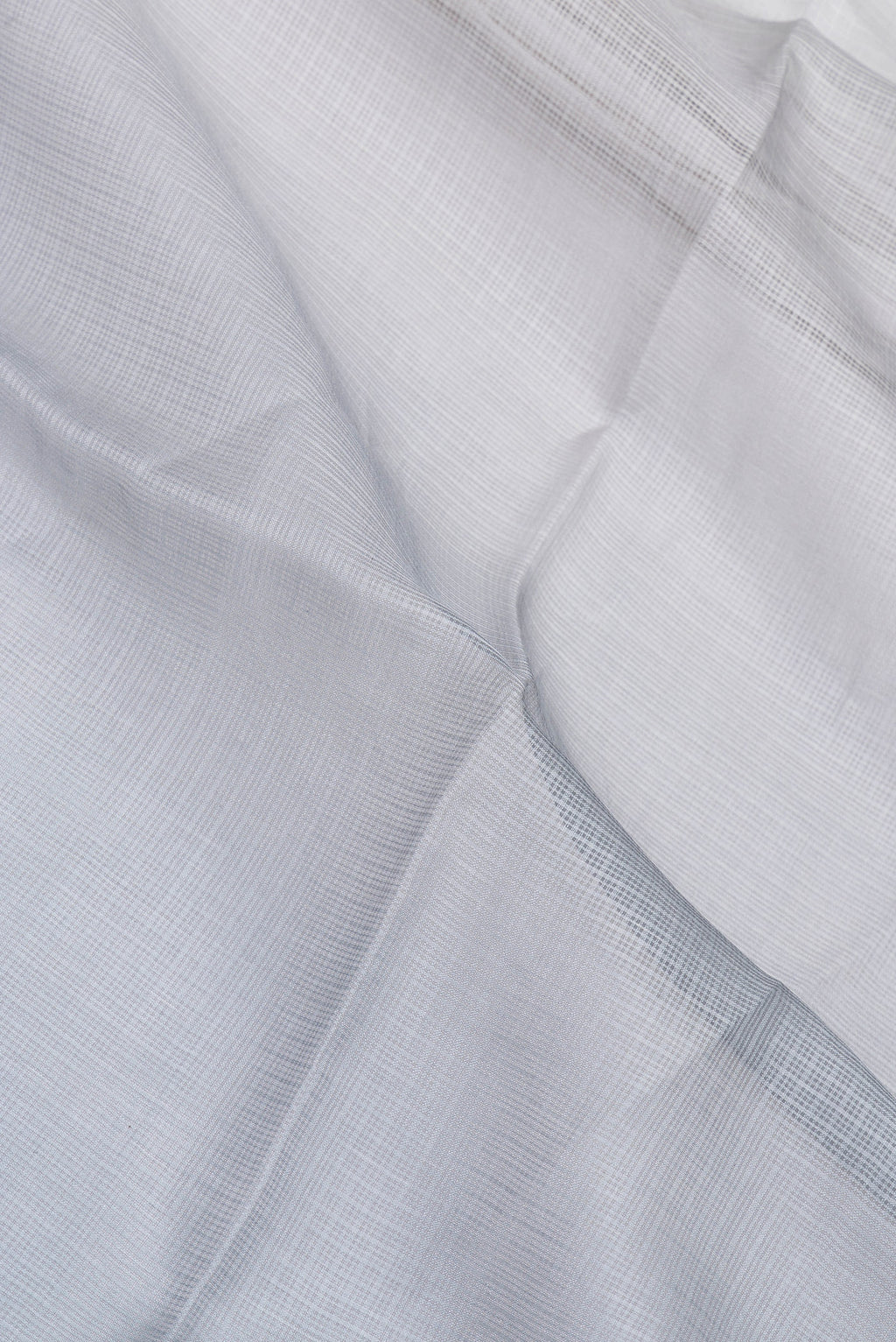 Close up of Grey Kota Silk Saree with Checked design on the body and Thin Zari Line.  displaying folds