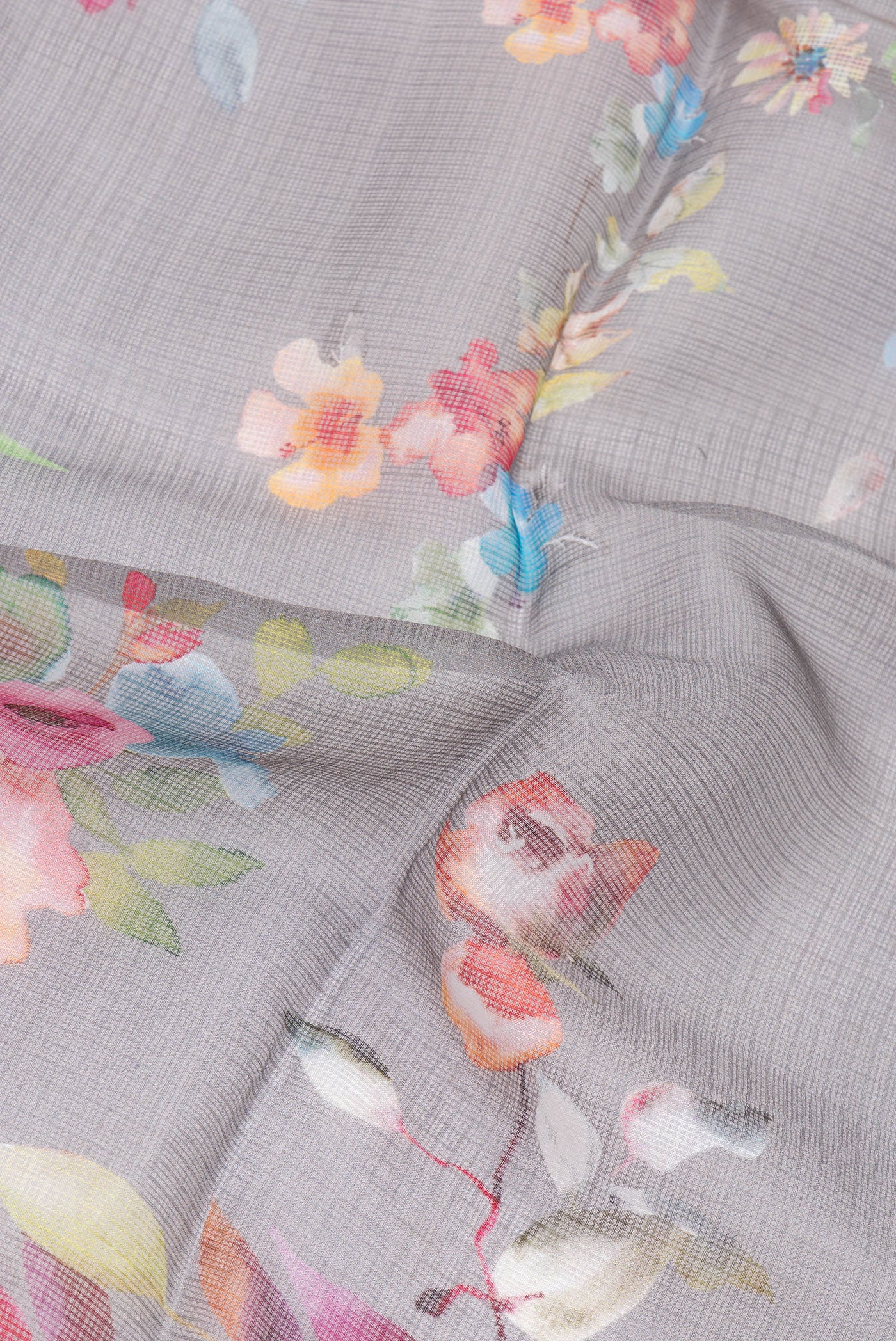 Close up of Grey Kota Silk Saree with Floral Print on the body and Plain Border.  displaying folds