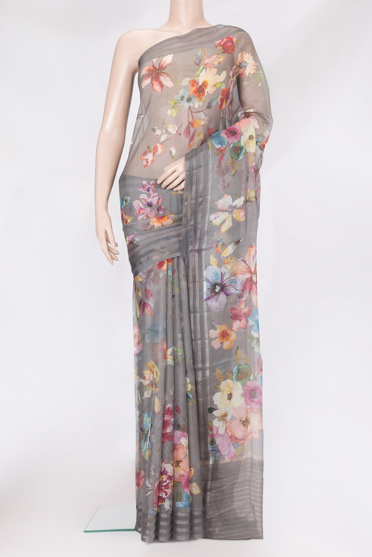 Grey Kota Silk Saree with Floral Print on the body and Plain Border.  displayed on a mannequin