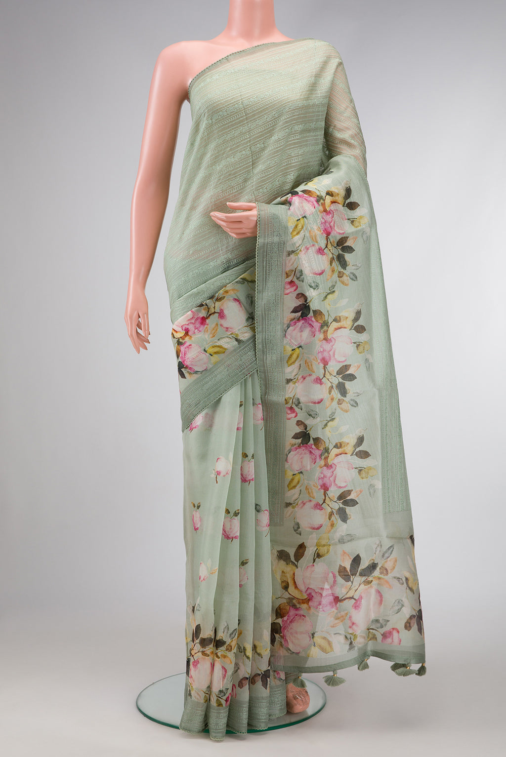 Pista Green Dual Tone Organza Silk Saree with Embroidery on the body and Embroidery Border.  displayed on a mannequin