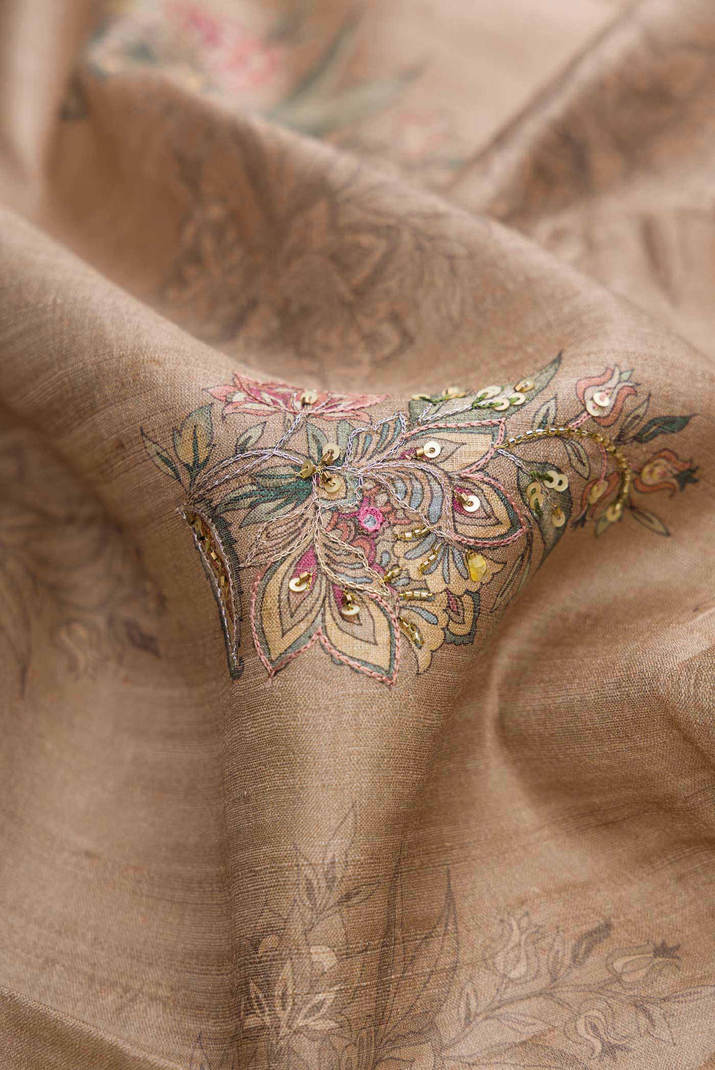 Close up of Dark Beige Dual Tone Tussar Silk Saree with Printed design on the body and Printed Border displaying folds
