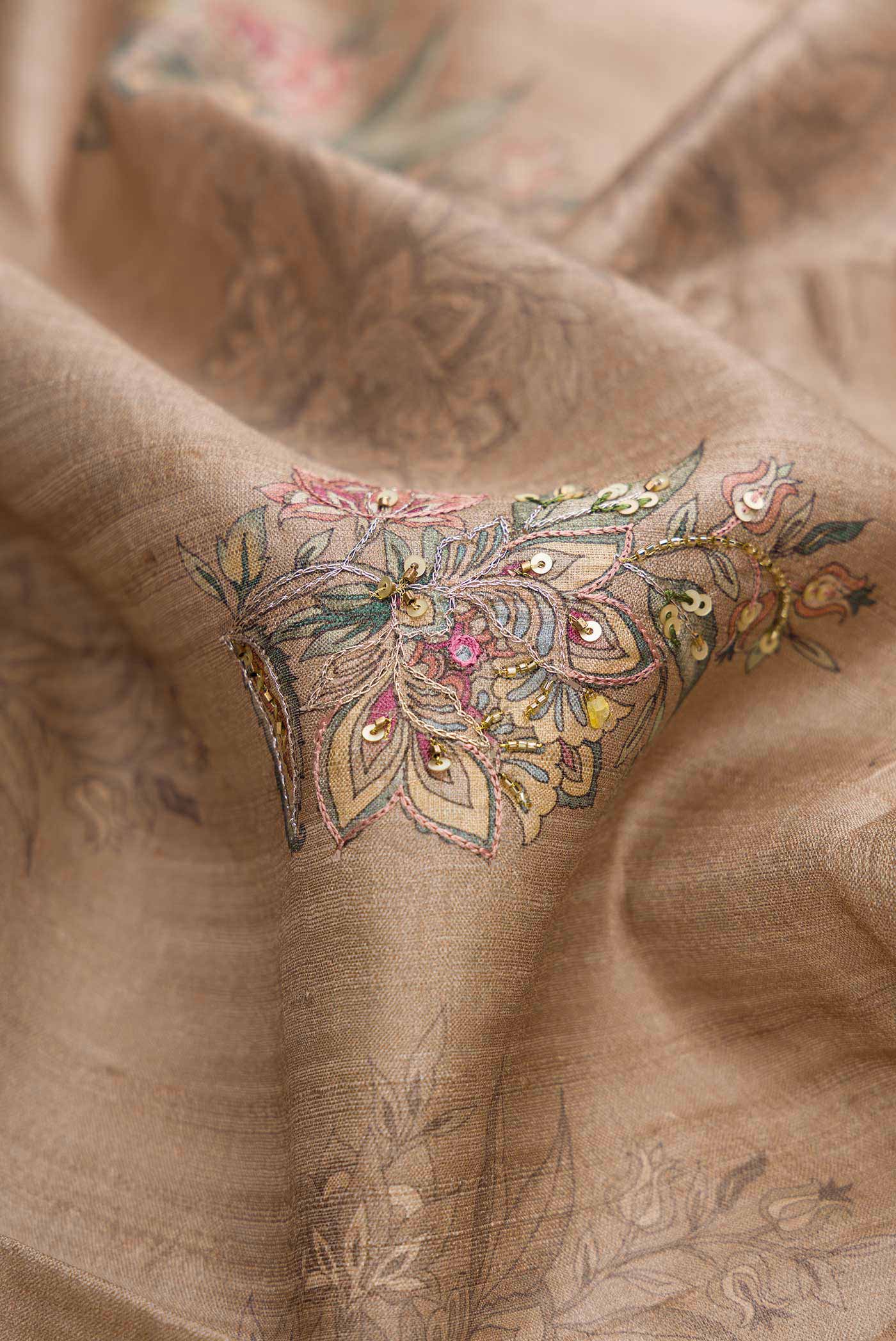 Close up of Dark Beige Dual Tone Tussar Silk Saree with Printed design on the body and Printed Border displaying folds