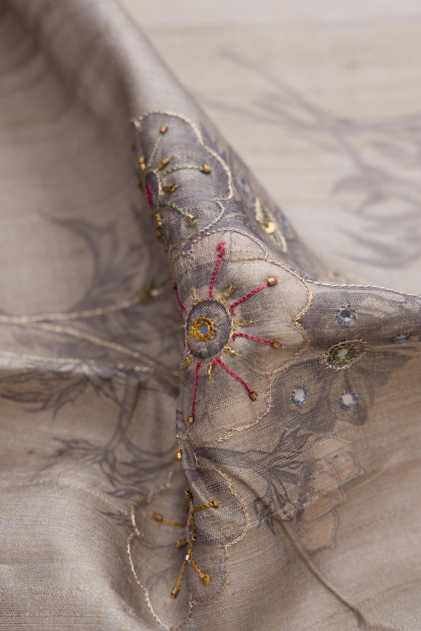 Close up of Grey Dual Tone Tussar Silk Saree with Embroidery on the body and Plain Border displaying folds