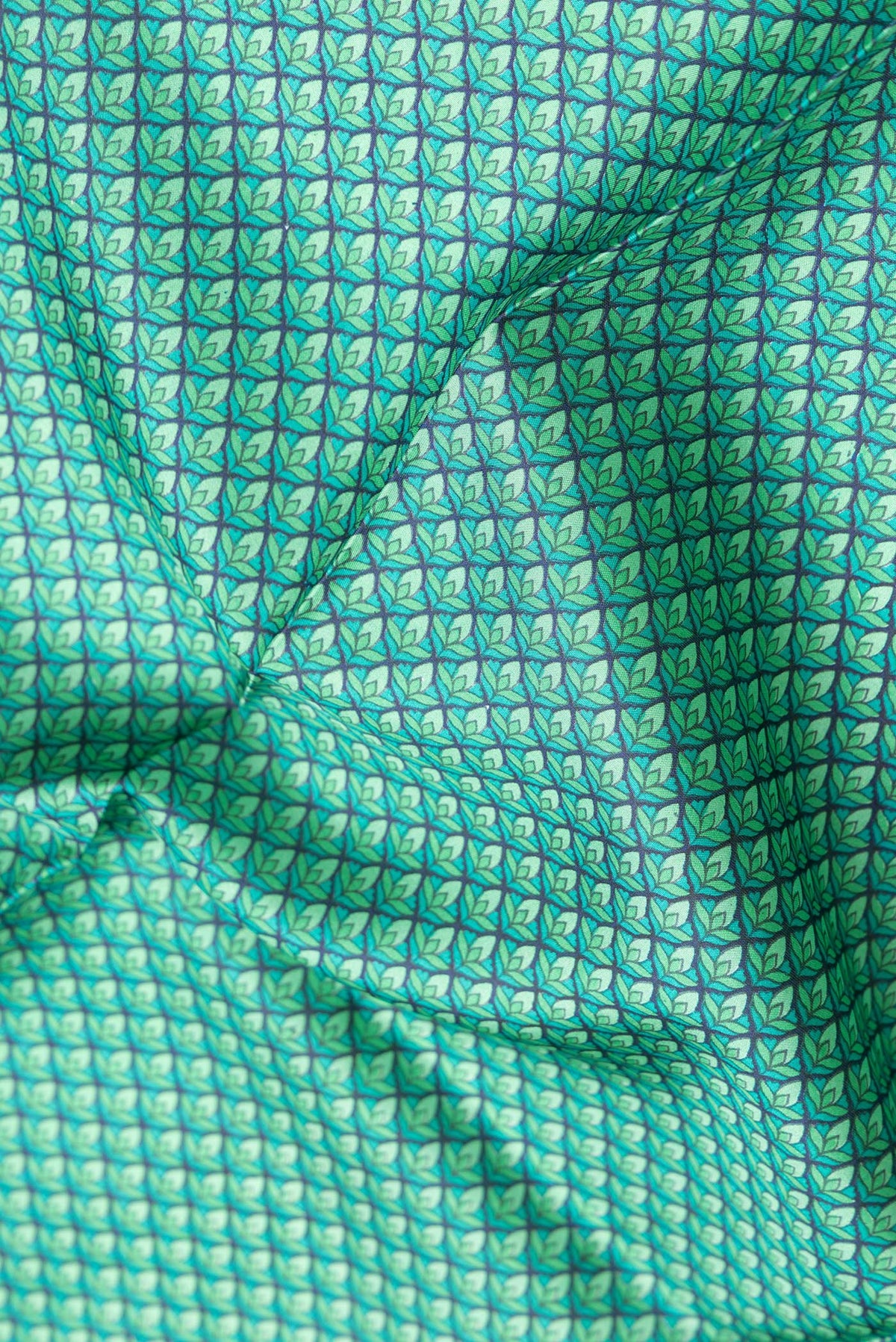 Close up of Peacock Blue Dual Tone Printed Silk Saree with Printed design on the body and Printed Border.  displaying folds
