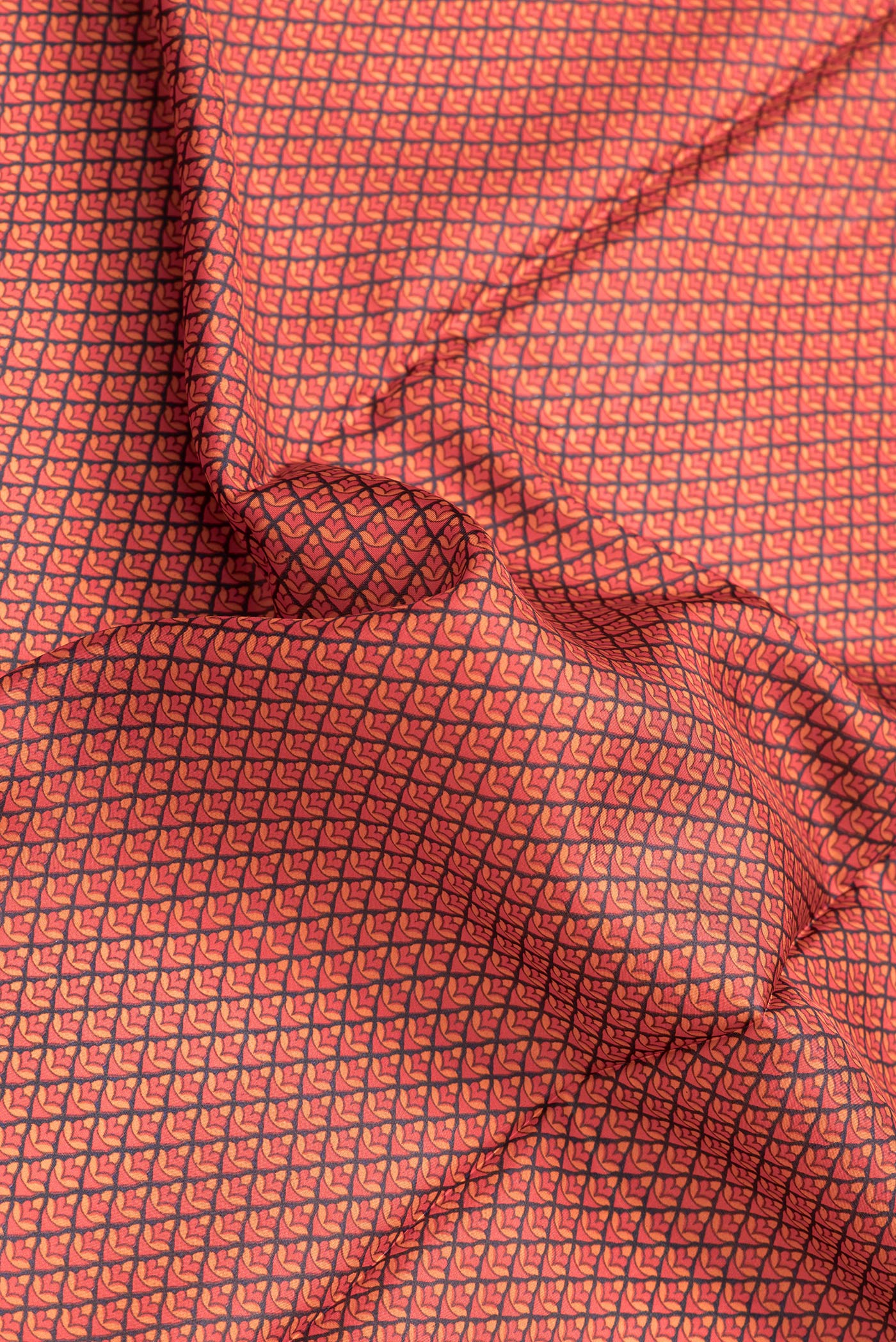 Close up of Red Dual Tone Printed Silk Saree with Printed design on the body and Printed Border.  displaying folds