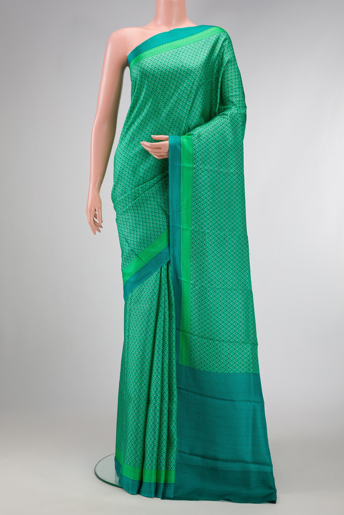 Sea Green Dual Tone Printed Silk Saree with Printed design on the body and Printed Border.  displayed on a mannequin