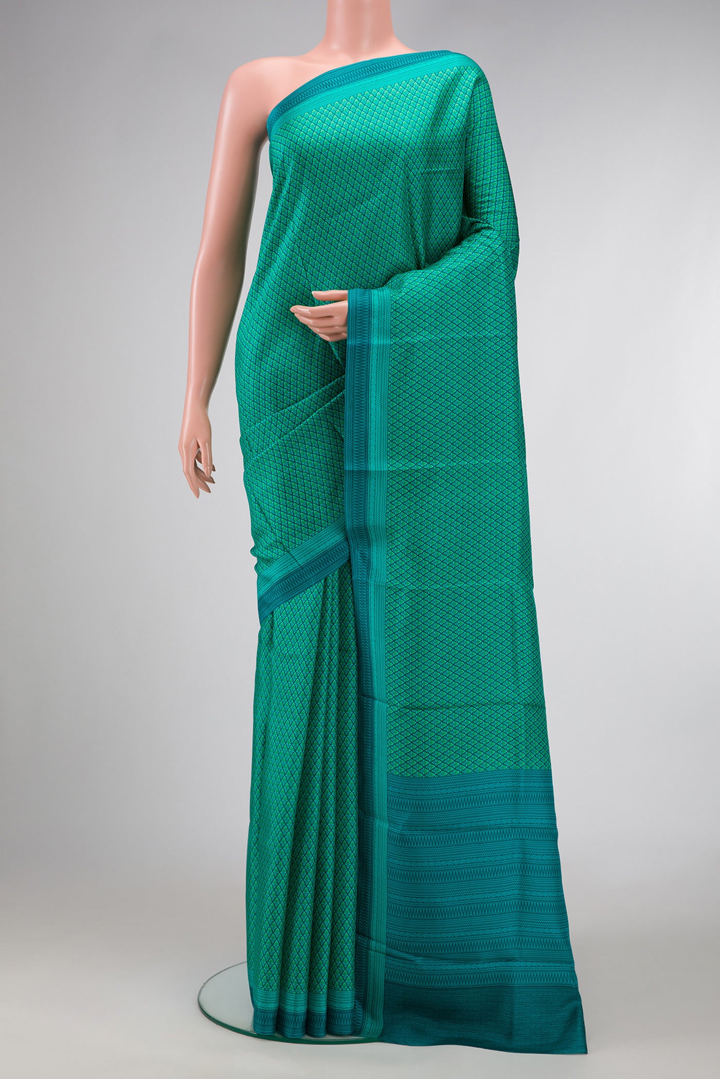Green Dual Tone Printed Silk Saree with Printed design on the body and Printed Border.  displayed on a mannequin